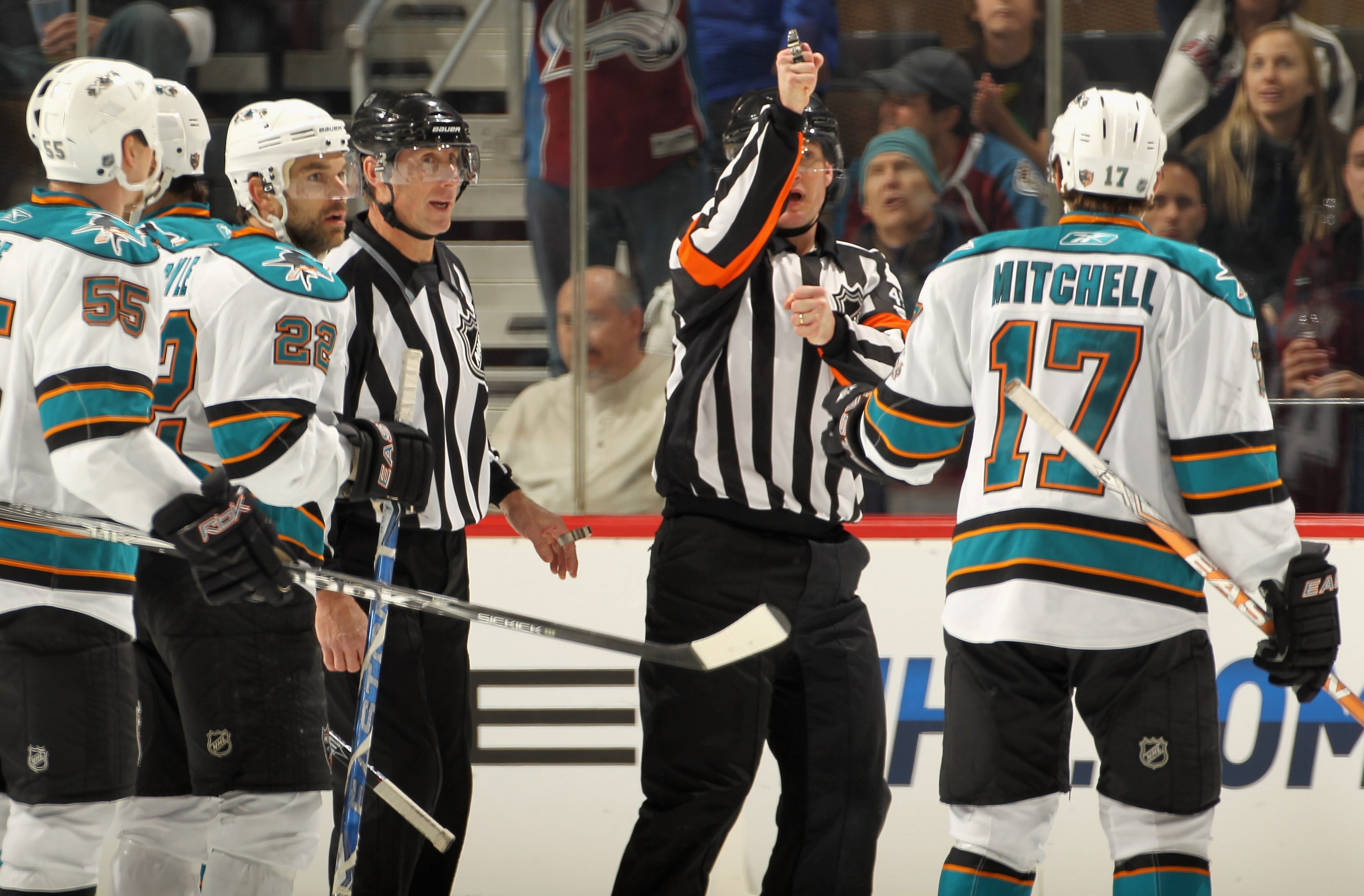 DENVER - NOVEMBER 17:  Referee Marcus Vinnerborg #45 makes a high sticking call against the San Jose Sharks that disallowed a third period goal and was confirmed by the replay official as Torrey Mitchell #17 of the the San Jose Sharks reacts in the third