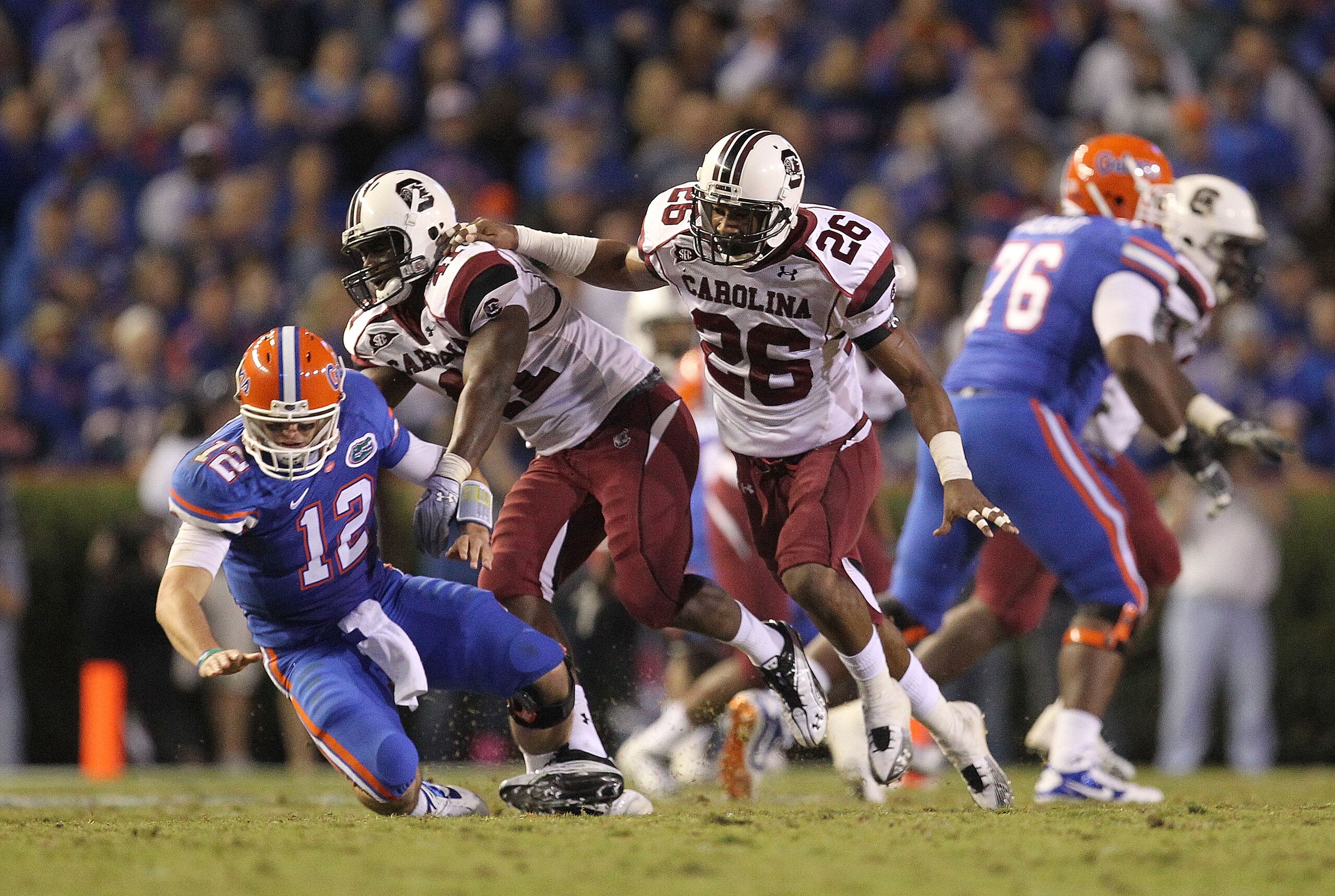 GAINESVILLE, FL - NOVEMBER 13:  Josh Dickerson #41 and Antonio Allen #26 of the South Carolina Gamecocks knock down quarterback John Brantley #12 of the Florida Gators during a game at Ben Hill Griffin Stadium on November 13, 2010 in Gainesville, Florida.