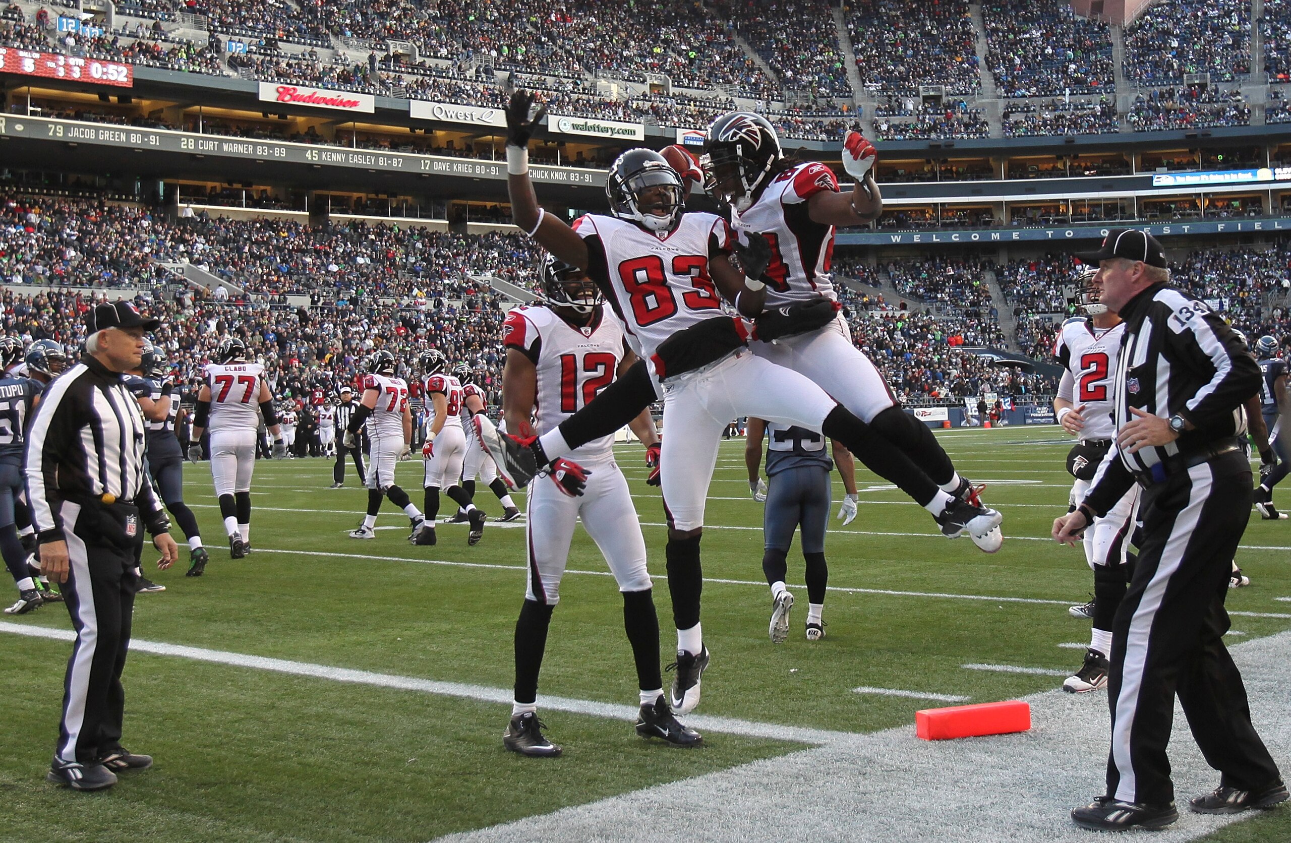 SEATTLE, WA - DECEMBER 19:  Wide receiver Roddy White #84 of the Atlanta Falcons celebrates with Harry Douglas #83 and Michael Jenkins #12 after scoring a touchdown against the Seattle Seahawks at Qwest Field on December 19, 2010 in Seattle, Washington. T