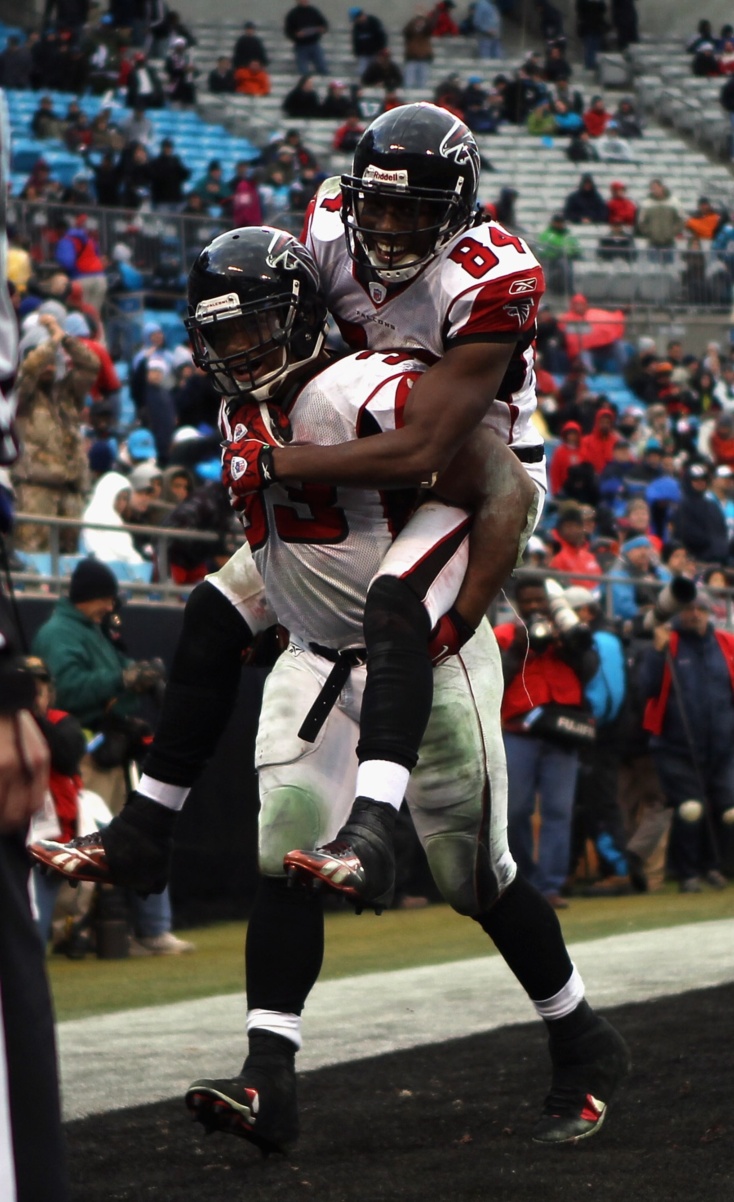 CHARLOTTE, NC - DECEMBER 12:  Teammates Roddy White #84 and Michael Turner #33 of the Atlanta Falcons celebrate after Turner scored a touchdown against the Carolina Panthers during their game at Bank of America Stadium on December 12, 2010 in Charlotte, N