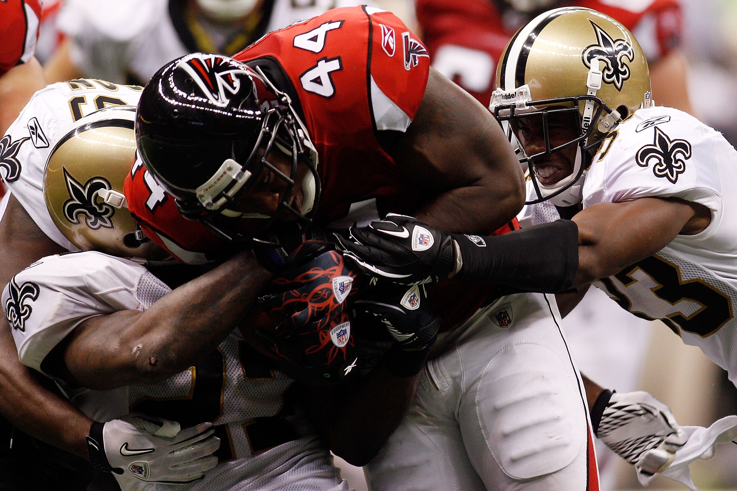 NEW ORLEANS - SEPTEMBER 26:  Jason Snelling #44 of the Atlanta Falcons is tackled by Malcom Jenkins #27 and Jabari Greer #33 of the New Orleans Saints at the Louisiana Superdome on September 26, 2010 in New Orleans, Louisiana.  The Falcons defeated the Sa