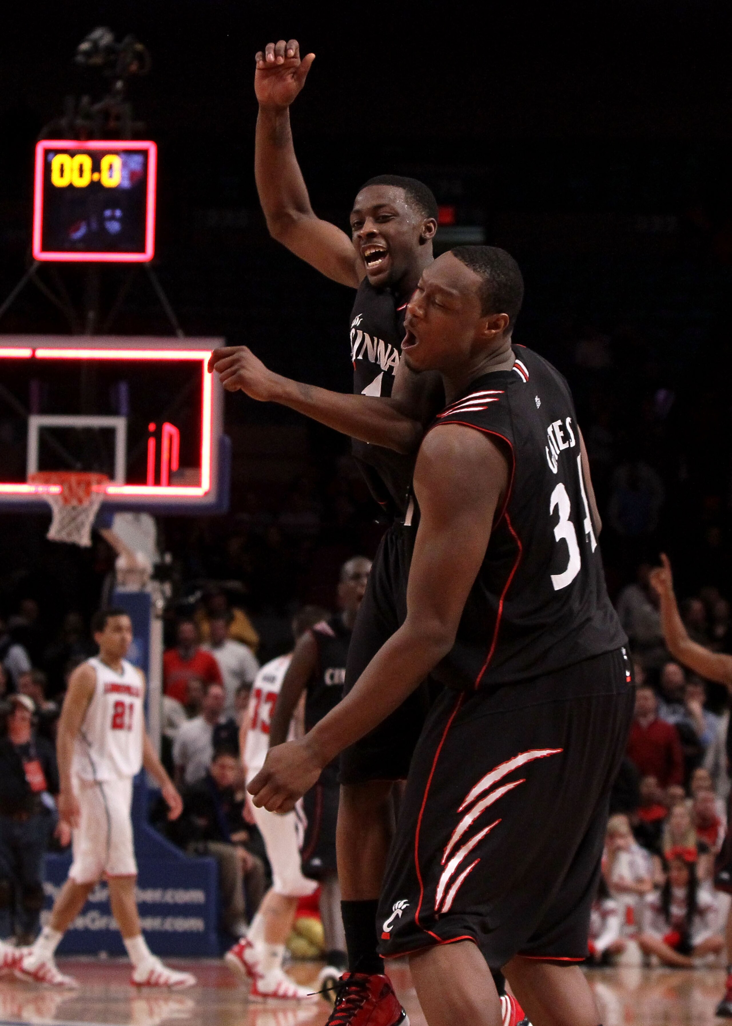 NEW YORK - MARCH 10: Cashmere Wright #1 and Yancy Gates #34 of the Cincinnati Bearcats celebrate after defeating the Louisville Cardinals during the second round of 2010 NCAA Big East Tournament at Madison Square Garden on March 10, 2010 in New York City.