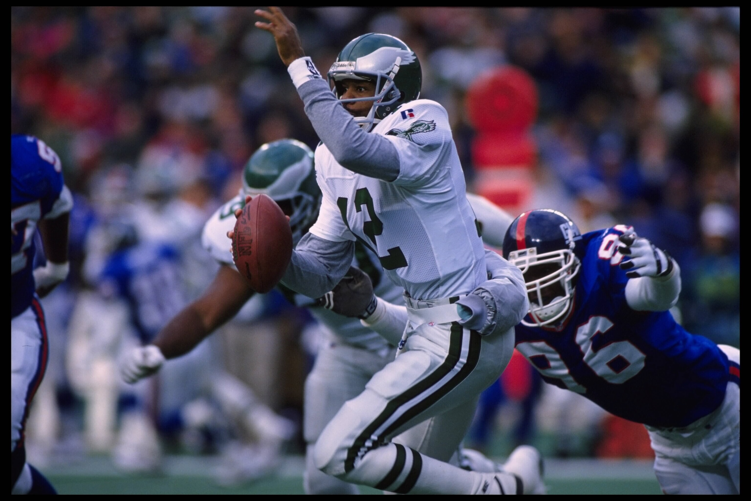 19 Nov 1995:   Quarterback Randall Cunningham #12 of the Philadelphia Eagles scrambles out of the pocket and tries to avoid a diving Jamal Duff #96 of the New York Giants during the Eagles 28-19 victory over the Giants at Veterans Stadium in Philadelphia,