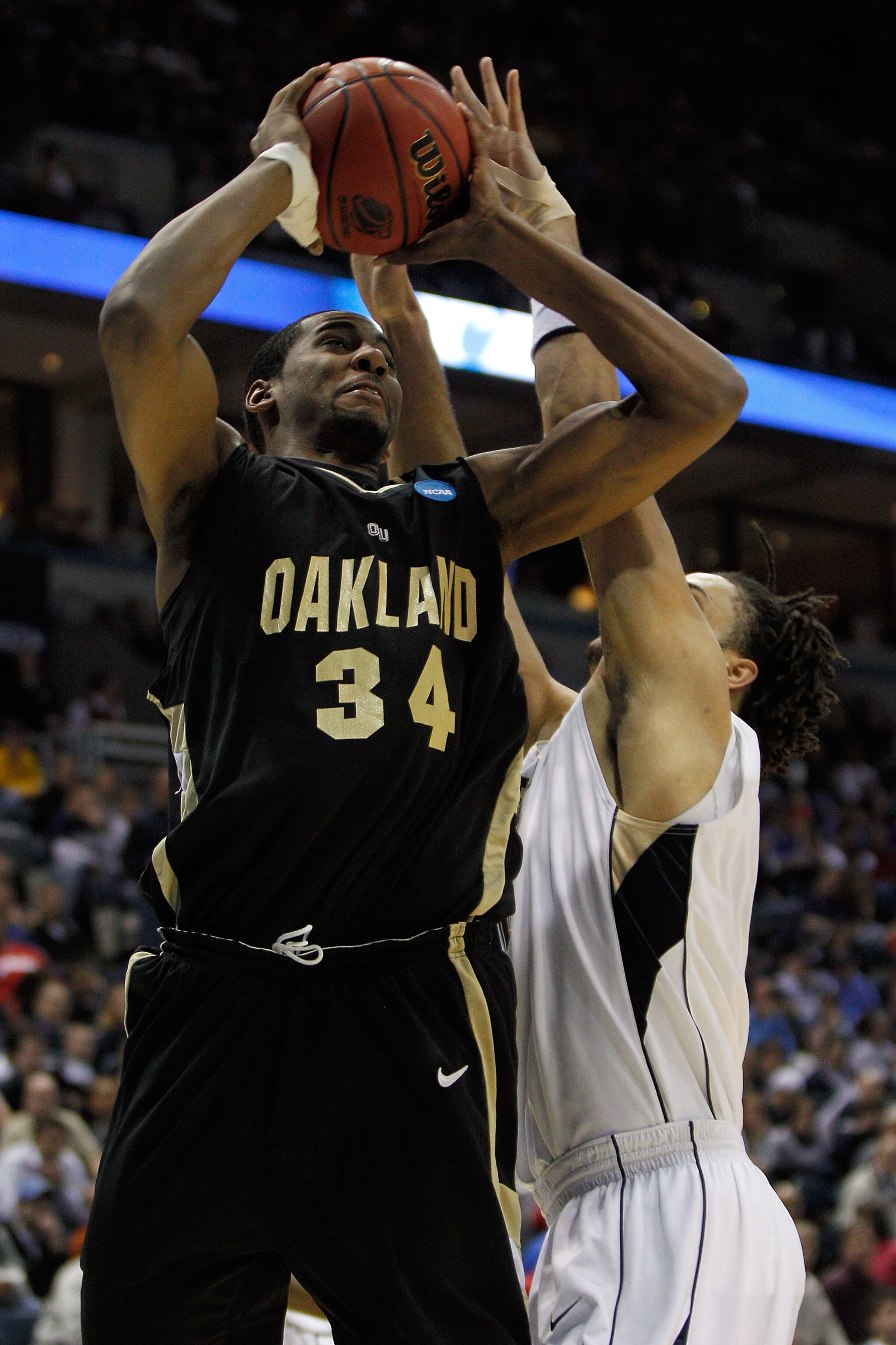 MILWAUKEE - MARCH 19:  Keith Benson #34 of the Oakland Golden Grizzlies shoots over Gary McGhee #52 of the of the Pittsburgh Panthers in the first half during the first round of the 2010 NCAA men's basketball tournament at the Bradley Center on March 19,