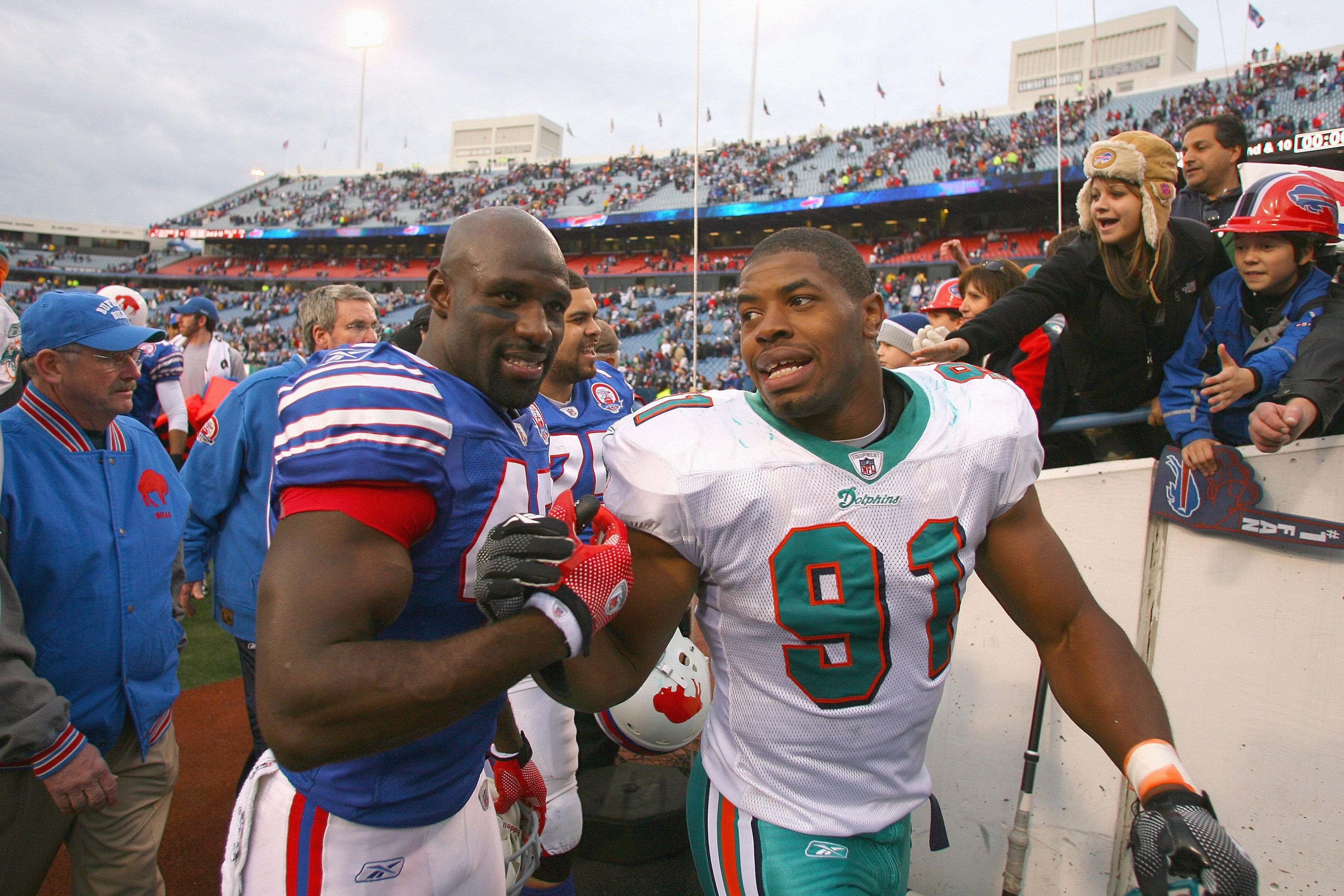 ORCHARD PARK, NY - NOVEMBER 29:  Bryan Scott #43 of the Buffalo Bills greets Cameron Wake #91 of the Miami Dolphins after the game at Ralph Wilson Stadium on November 29, 2009 in Orchard Park, New York. Buffalo won 31-14. (Photo by Rick Stewart/Getty Imag
