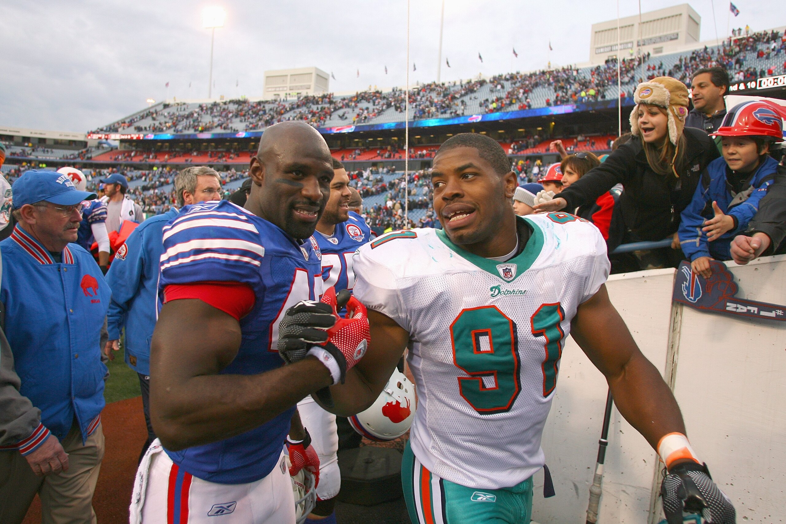 ORCHARD PARK, NY - NOVEMBER 29:  Bryan Scott #43 of the Buffalo Bills greets Cameron Wake #91 of the Miami Dolphins after the game at Ralph Wilson Stadium on November 29, 2009 in Orchard Park, New York. Buffalo won 31-14. (Photo by Rick Stewart/Getty Imag