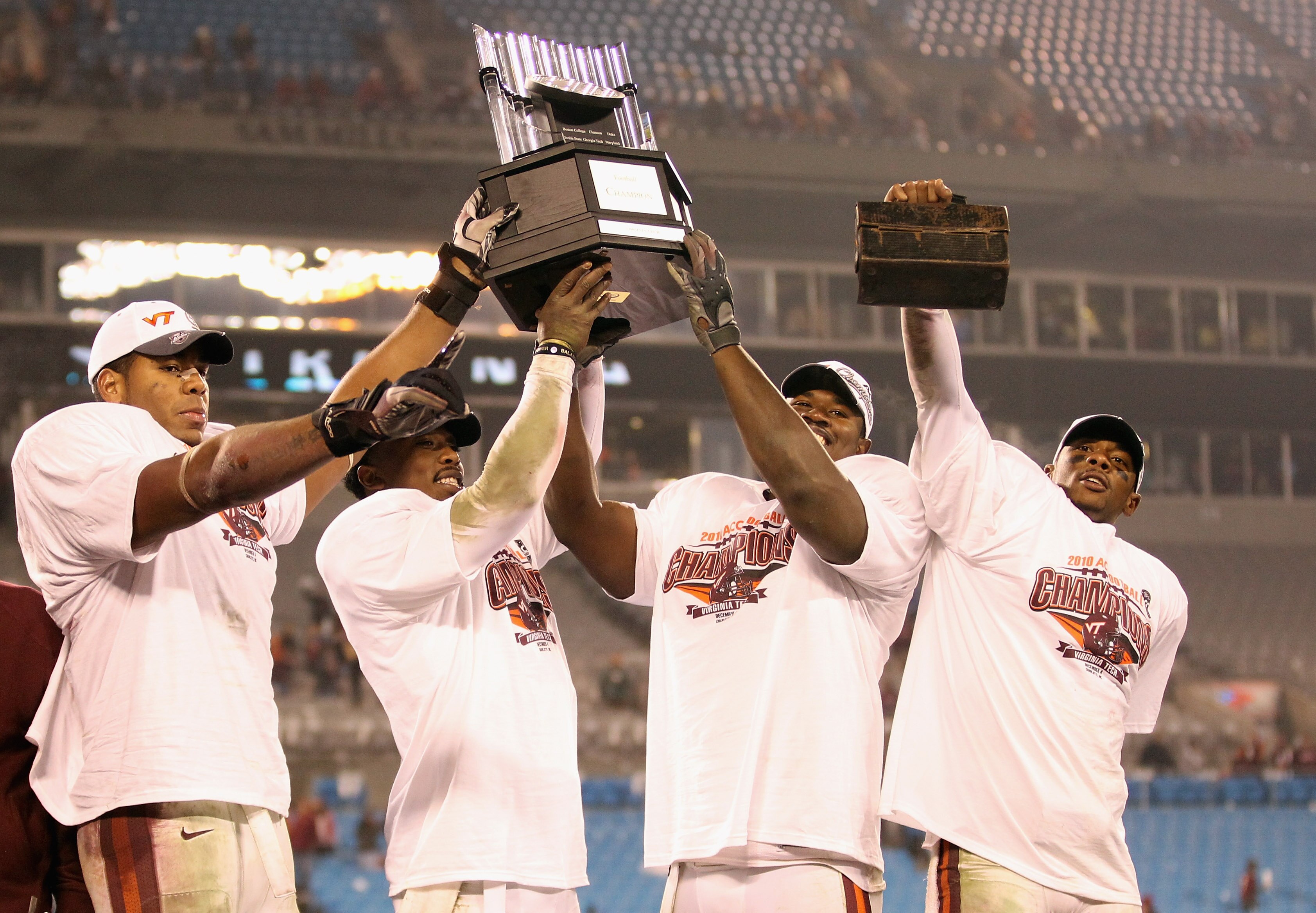 CHARLOTTE, NC - DECEMBER 04:  Teammates Andre Smith #88, Tyrod Taylor #5, John Graves #91 and Davon Morgan #2 of the Virginia Tech Hokies celebrate after winning the ACC Championship 44-33 after their game at Bank of America Stadium on December 4, 2010 in
