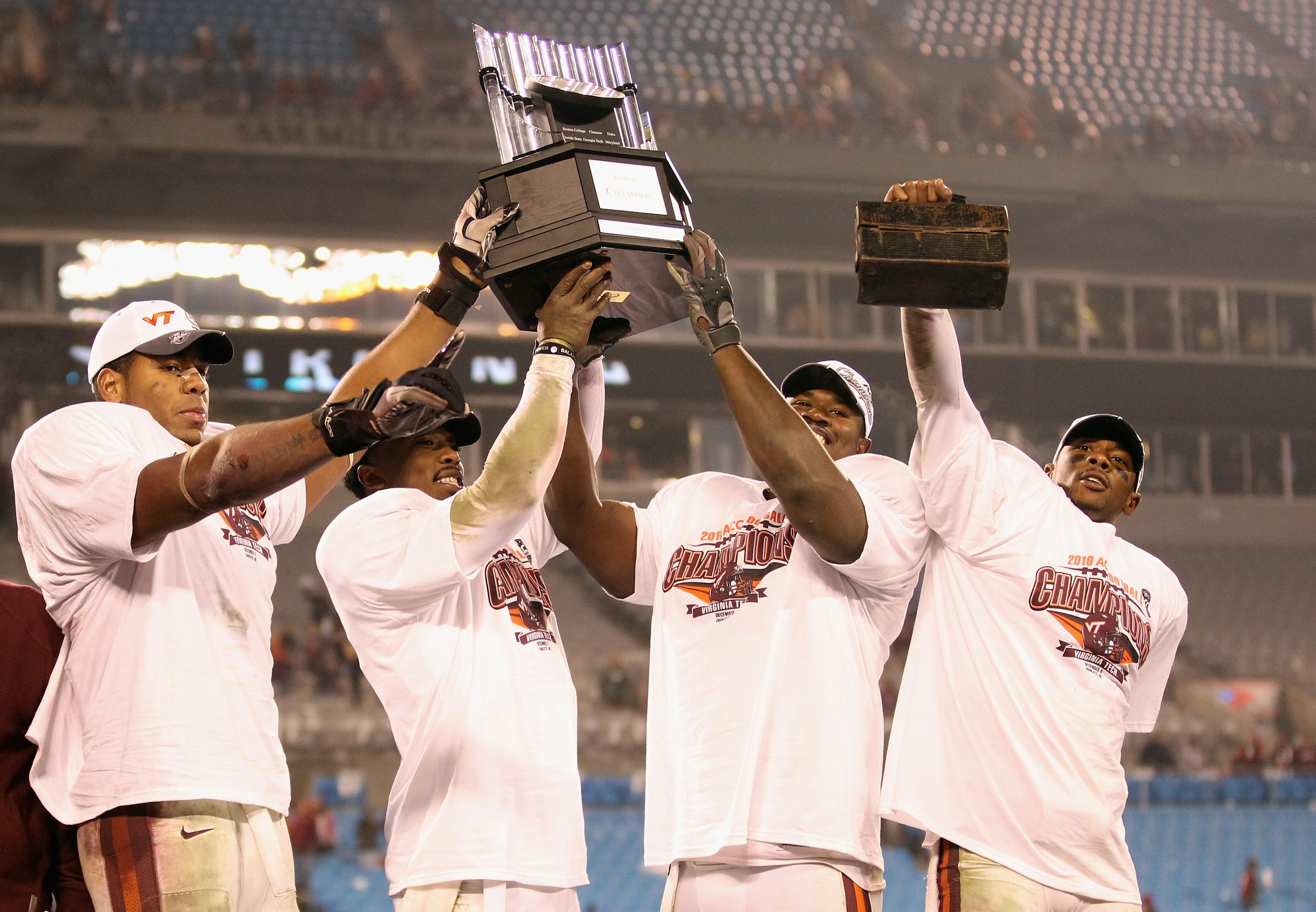 CHARLOTTE, NC - DECEMBER 04:  Teammates Andre Smith #88, Tyrod Taylor #5, John Graves #91 and Davon Morgan #2 of the Virginia Tech Hokies celebrate after winning the ACC Championship 44-33 after their game at Bank of America Stadium on December 4, 2010 in