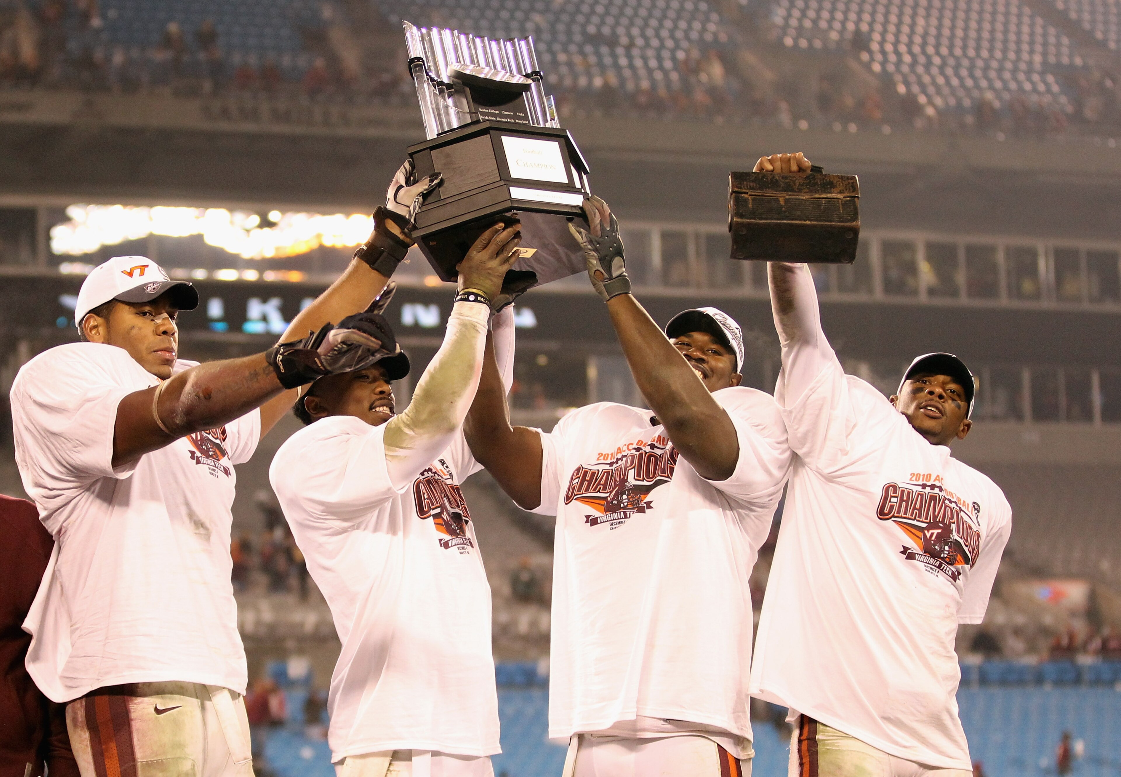 CHARLOTTE, NC - DECEMBER 04:  Teammates Andre Smith #88, Tyrod Taylor #5, John Graves #91 and Davon Morgan #2 of the Virginia Tech Hokies celebrate after winning the ACC Championship 44-33 after their game at Bank of America Stadium on December 4, 2010 in