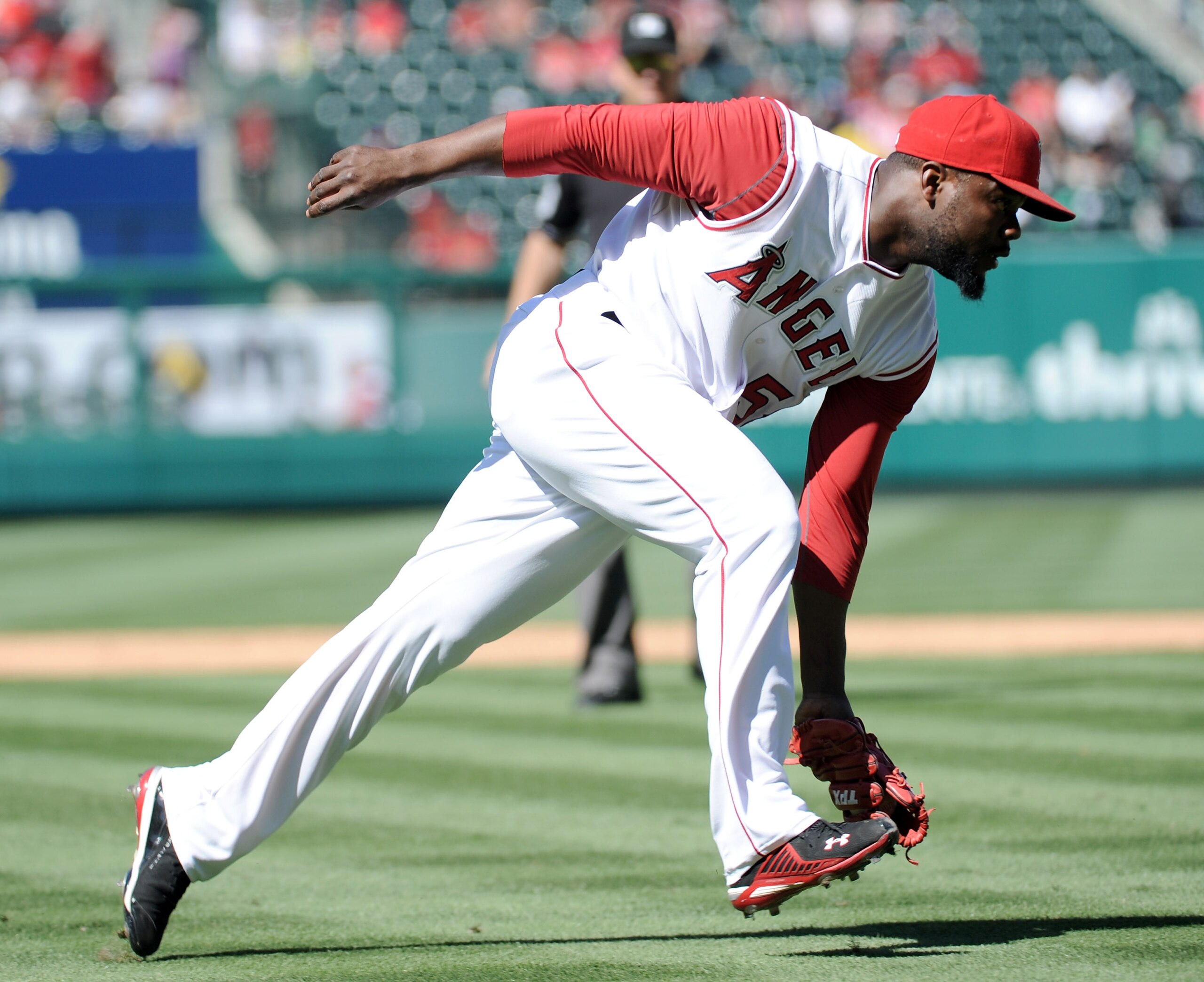 ANAHEIM, CA - SEPTEMBER 12:  Fernando Rodney #56 of the Los Angeles Angels of Anaheim fields a groundball against the Seattle Mariners during the ninth inning at Angel Stadium on September 12, 2010 in Anaheim, California.  Angels won 3-0.  (Photo by Harry