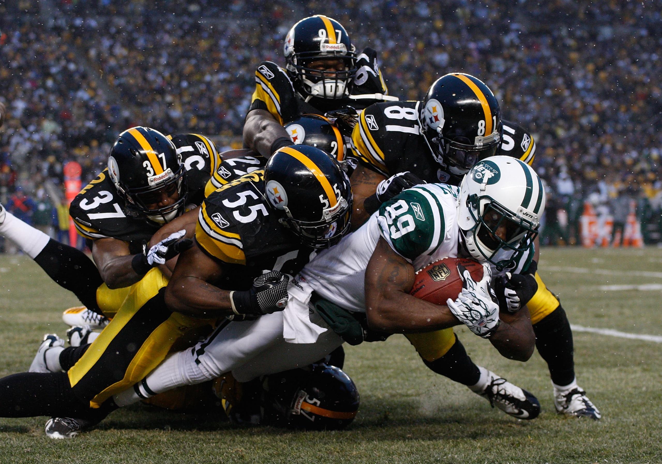 PITTSBURGH - DECEMBER 19:  Members of the Pittsburgh Steelers special teams including Jason Worilds #97, Ryan Mundy #29, Anthony Madison #37, Stevenson Sylvester #55, and Arnaz Battle #81 make a tackle on Jerricho Cotchery #89 of the New York Jets during 