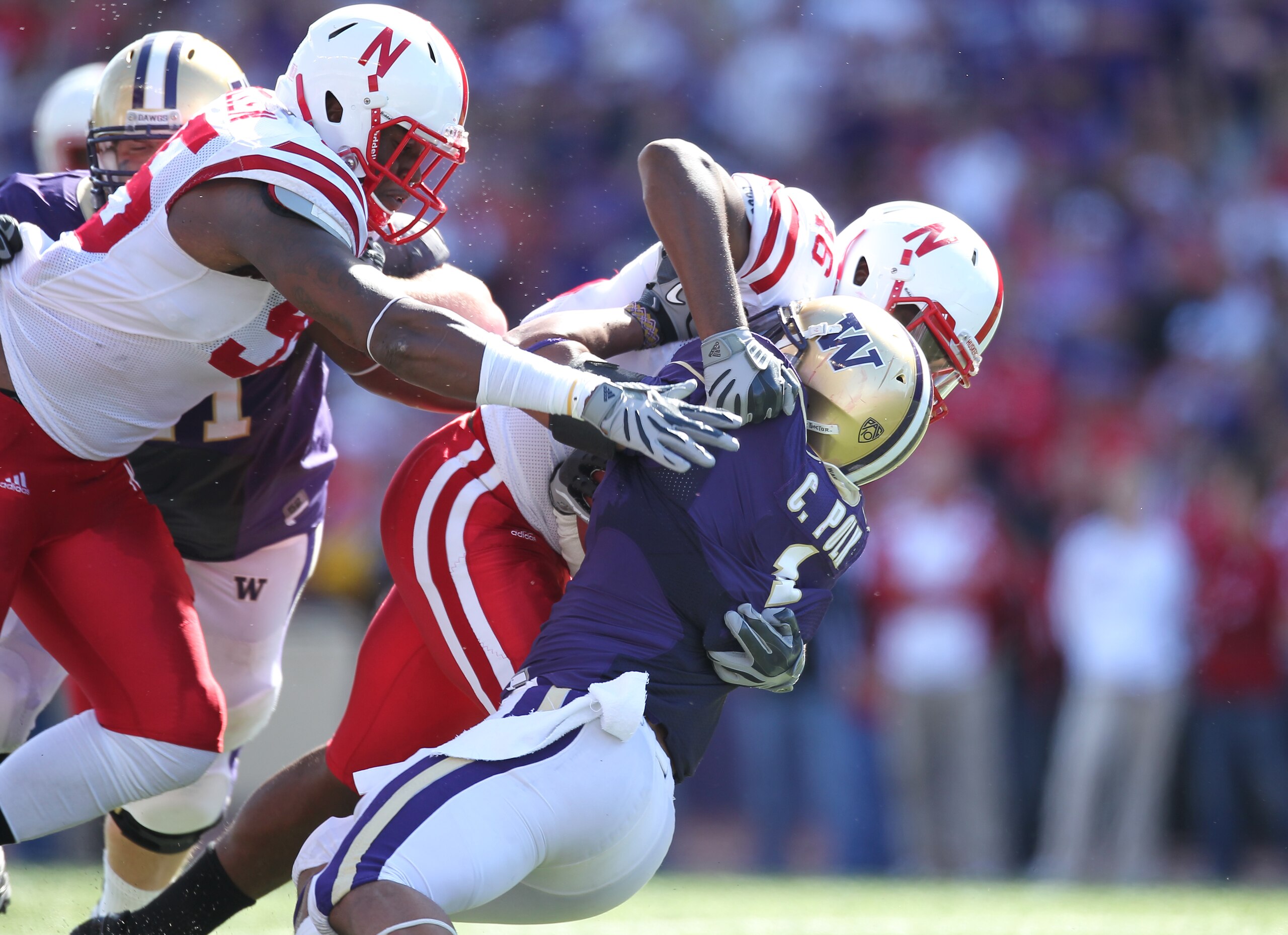 SEATTLE - SEPTEMBER 18: Running back Chris Polk #1 of the Washington Huskies is tackled by linebacker Eric Martin #46 and defensive end Pierre Allen #95 of the Nebraska Cornhuskers on September 18, 2010 at Husky Stadium in Seattle, Washington. (Photo by O