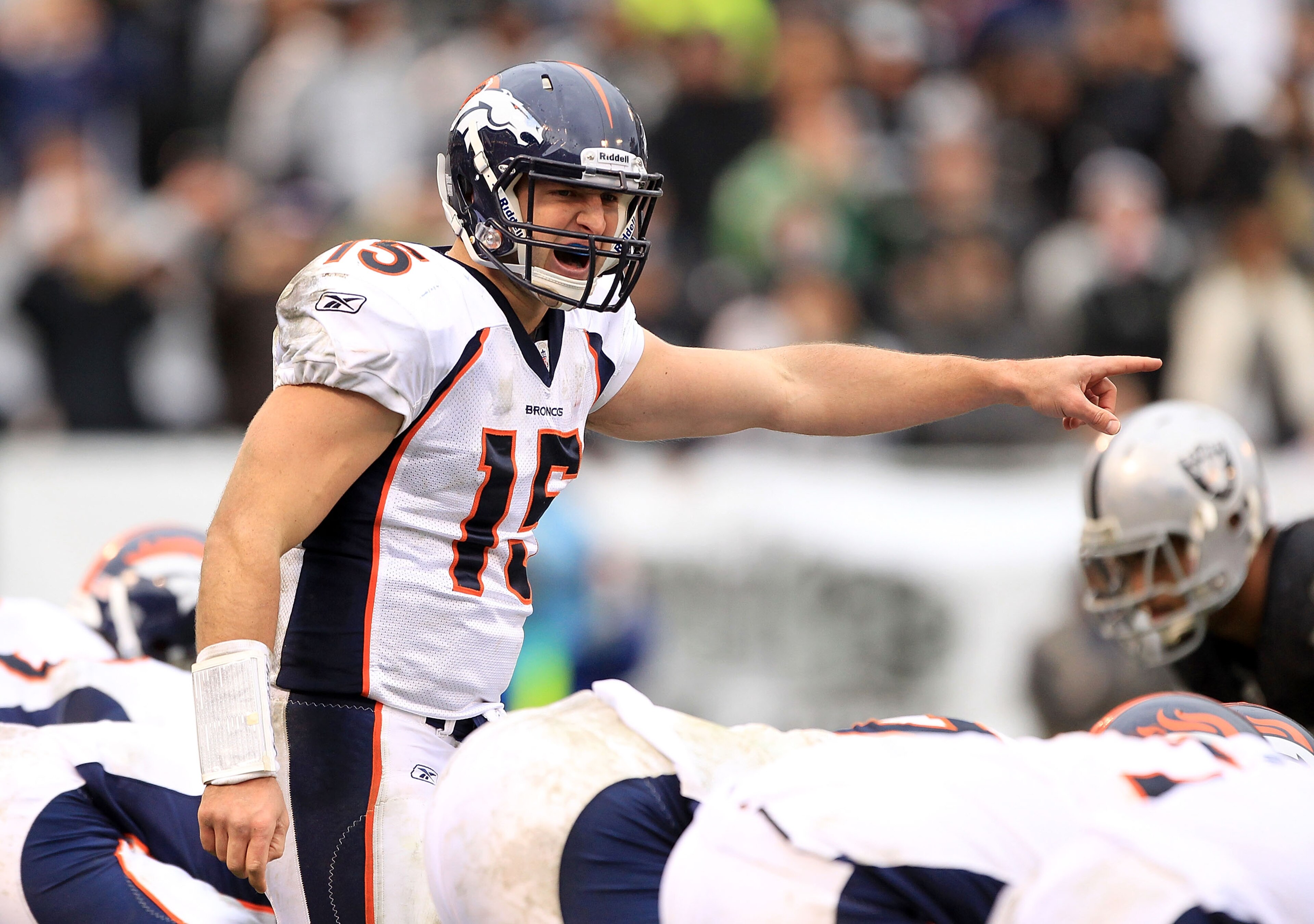 OAKLAND, CA - DECEMBER 19:  Tim Tebow #15 of the Denver Broncos shouts instructions to his team during their game against the Oakland Raiders at Oakland-Alameda County Coliseum on December 19, 2010 in Oakland, California.  (Photo by Ezra Shaw/Getty Images