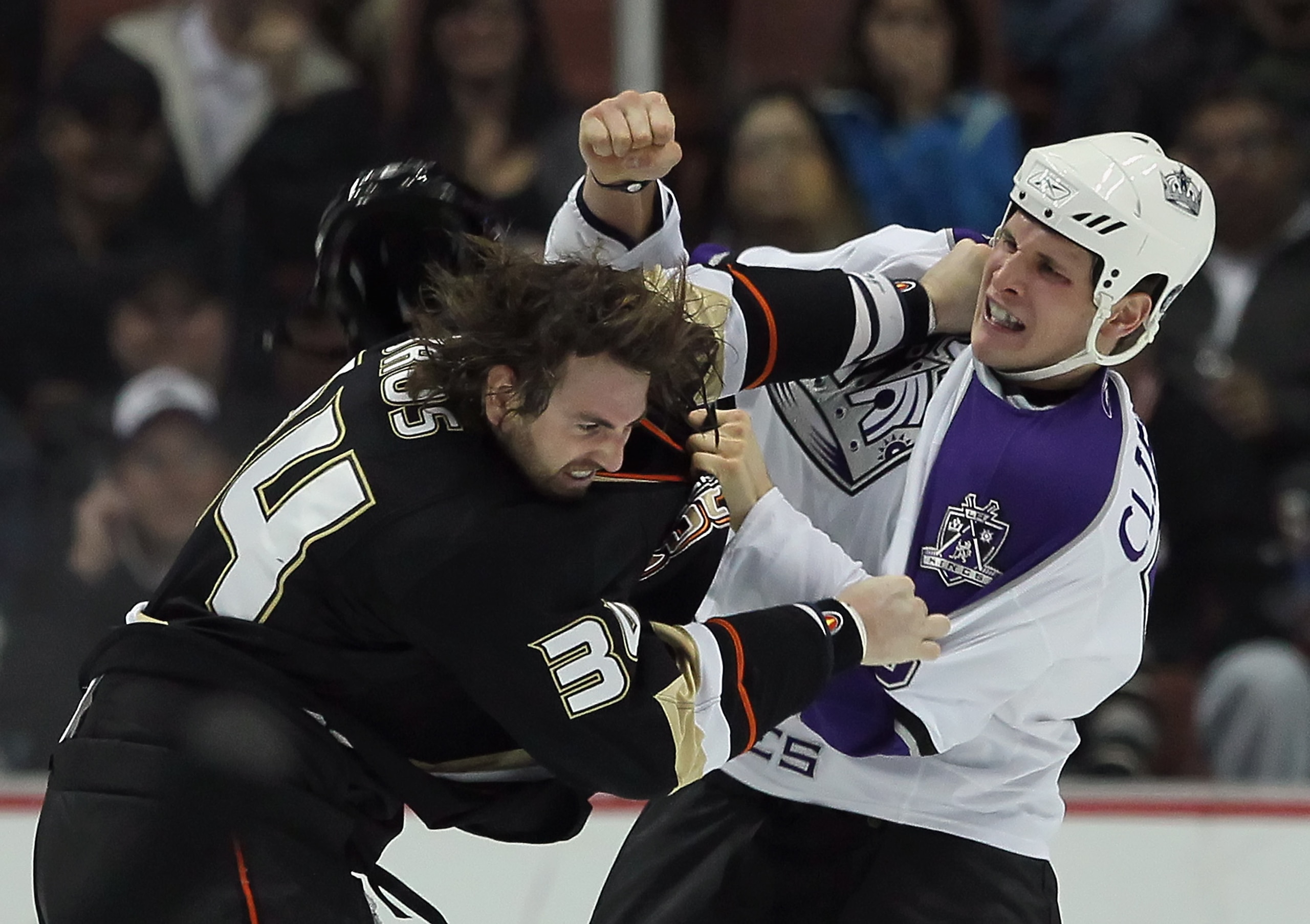 ANAHEIM, CA - NOVEMBER 29:  Kyle Clifford (R) #13 of the Los Angeles Kings throws a punch at Aaron Voros #34 of the Anaheim Ducks during the first period at the Honda Center on November 29, 2010 in Anaheim, California.  (Photo by Jeff Gross/Getty Images)