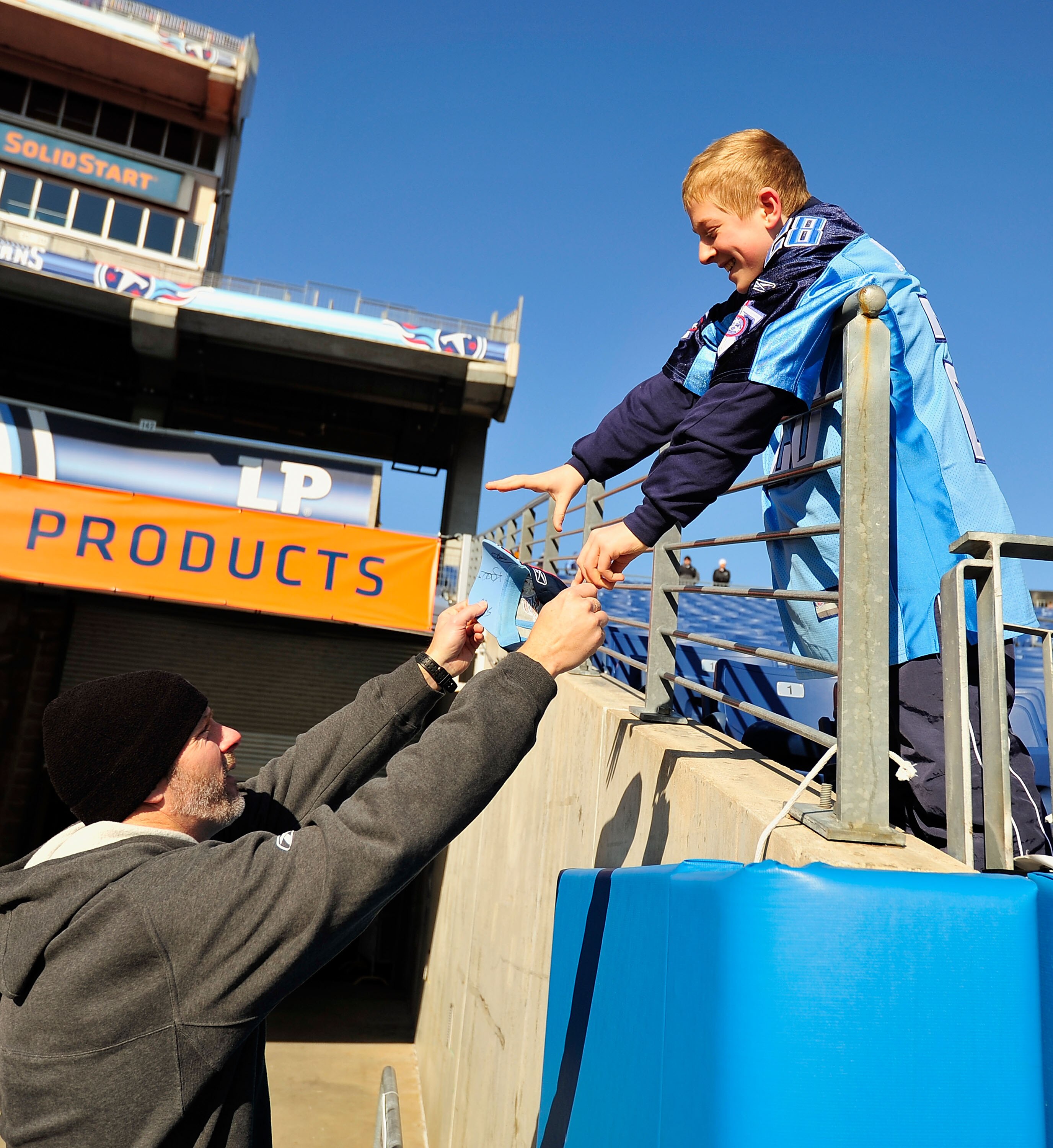 NASHVILLE, TN - DECEMBER 19:  Kerry Collins #5 of the Tennessee Titans signs an autograph for a fan before a game against the Houston Texans at LP Field on December 19, 2010 in Nashville, Tennessee.  (Photo by Grant Halverson/Getty Images)