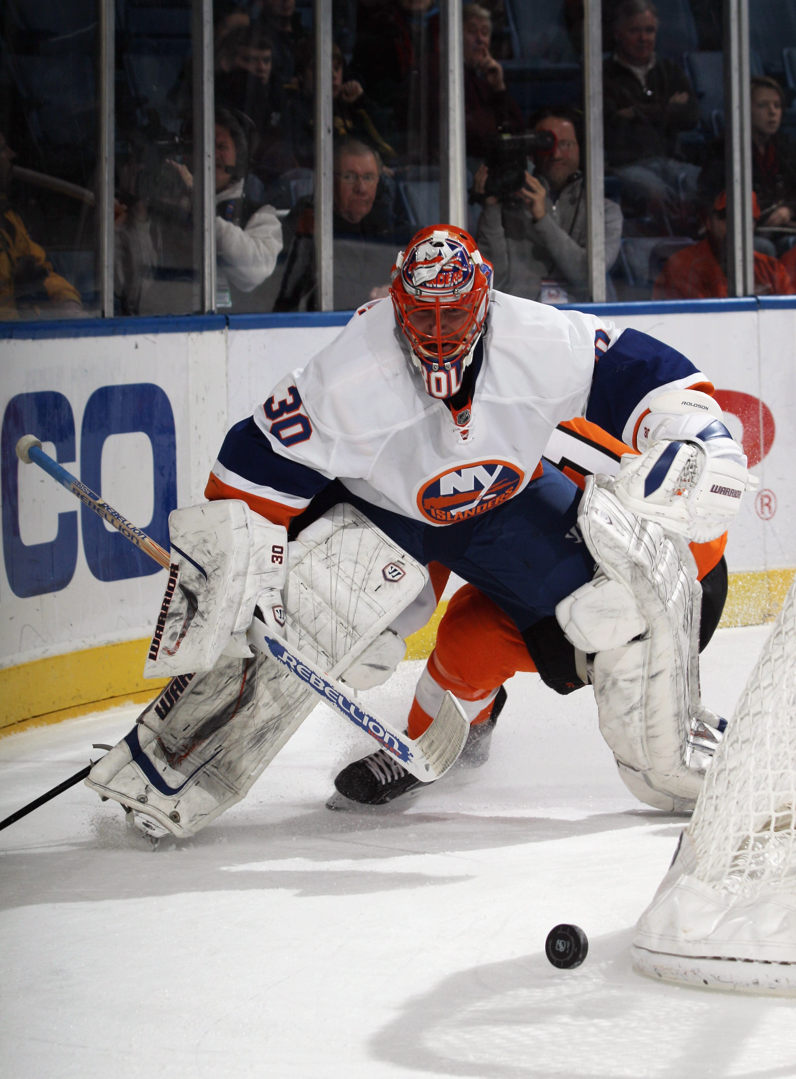UNIONDALE, NY - DECEMBER 05: Dwayne Roloson #30 of the New York Islanders plays the puck against teh Philadelphia Flyers at the Nassau Coliseum on December 5, 2010 in Uniondale, New York.  (Photo by Bruce Bennett/Getty Images)