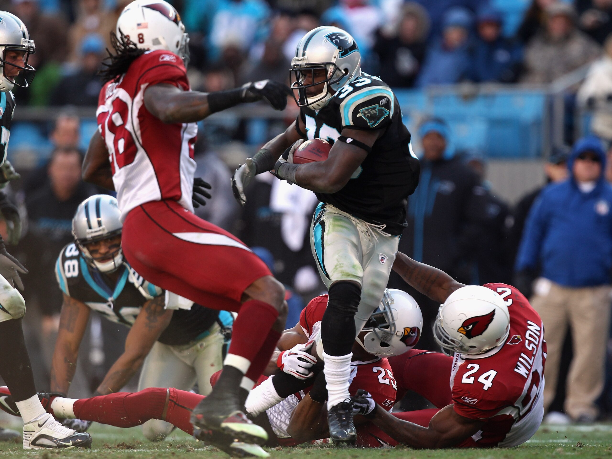 CHARLOTTE, NC - DECEMBER 19:  The defense of the Arizona Cardinals tries to stop Mike Goodson #33 of the Carolina Panthers during their game at Bank of America Stadium on December 19, 2010 in Charlotte, North Carolina.  (Photo by Streeter Lecka/Getty Imag