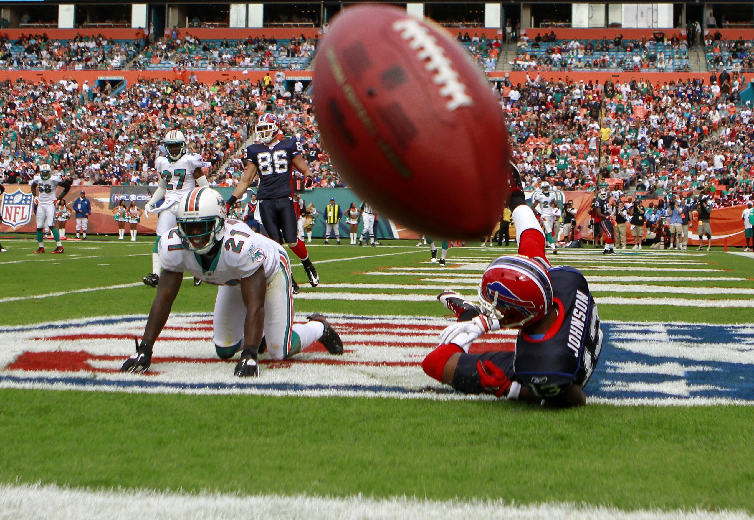 MIAMI - DECEMBER 19:  Defensive back Vonte Davis #21 of the Miami Dolphins breaks up a catch against receiver Steve Johnson #13 of the Buffalo Bills at Sun Life Stadium on December 19, 2010 in Miami, Florida. The Bills defeated the Dolphins 17-14.  (Photo