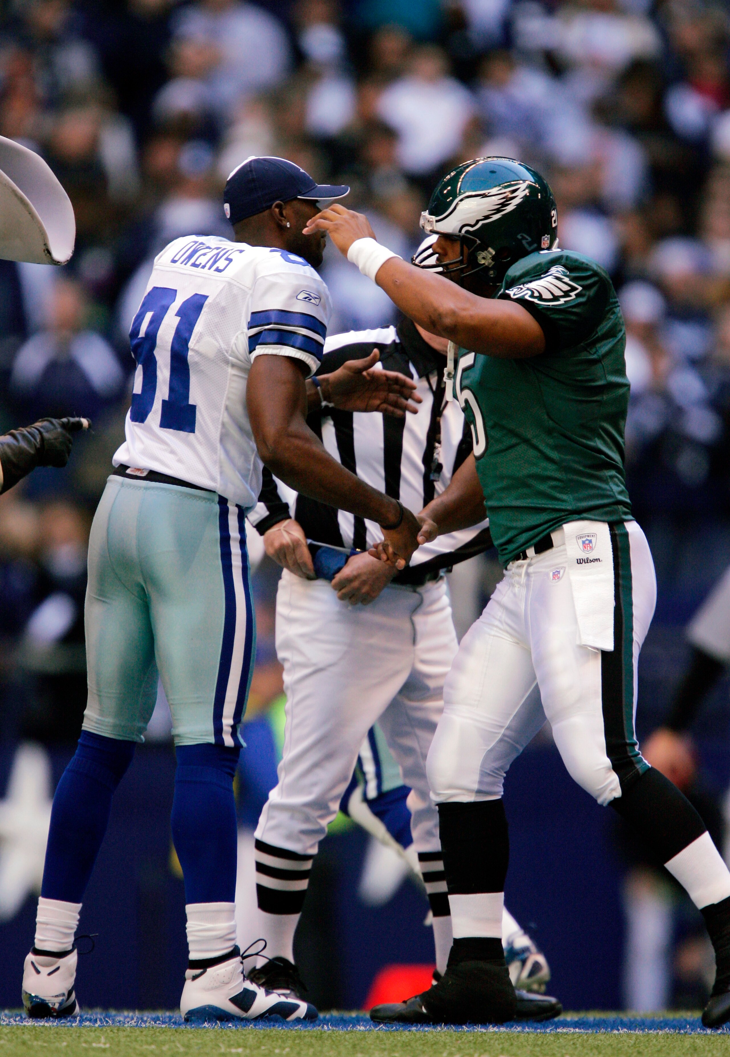 DALLAS - DECEMBER 16:  Wide receiver Terrell Owens #81 of the Dallas Cowboys greets his former teammate quarterback Donovan McNabb #5 of the Philadelphia Eagles, after the coin toss at Texas Stadium December 16, 2007 in Dallas, Texas.  (Photo by Brian Bah