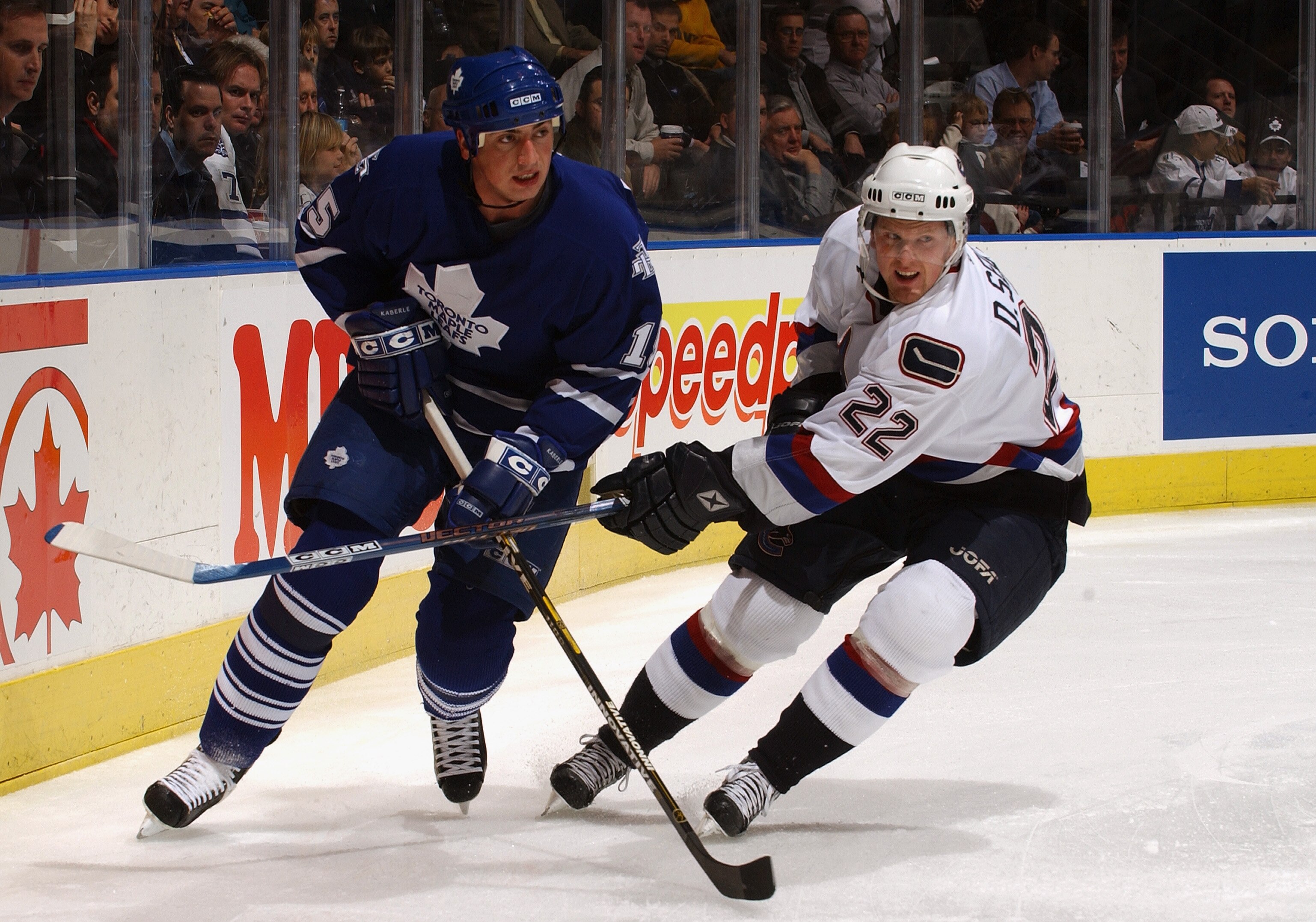 TORONTO - NOVEMBER 24:  Defenseman Tomas Kaberle #15 of the Toronto Maple Leafs and left wing Daniel Sedin #22 of the Vancouver Canucks skate on the ice during the game at the Air Canada Centre on November 24, 2003 in Toronto, Ontario. The Leafs won 2-1.
