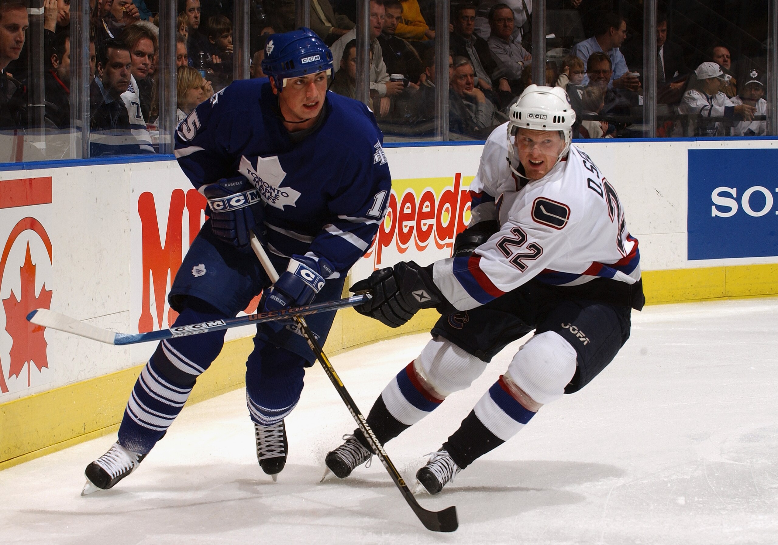 TORONTO - NOVEMBER 24:  Defenseman Tomas Kaberle #15 of the Toronto Maple Leafs and left wing Daniel Sedin #22 of the Vancouver Canucks skate on the ice during the game at the Air Canada Centre on November 24, 2003 in Toronto, Ontario. The Leafs won 2-1.