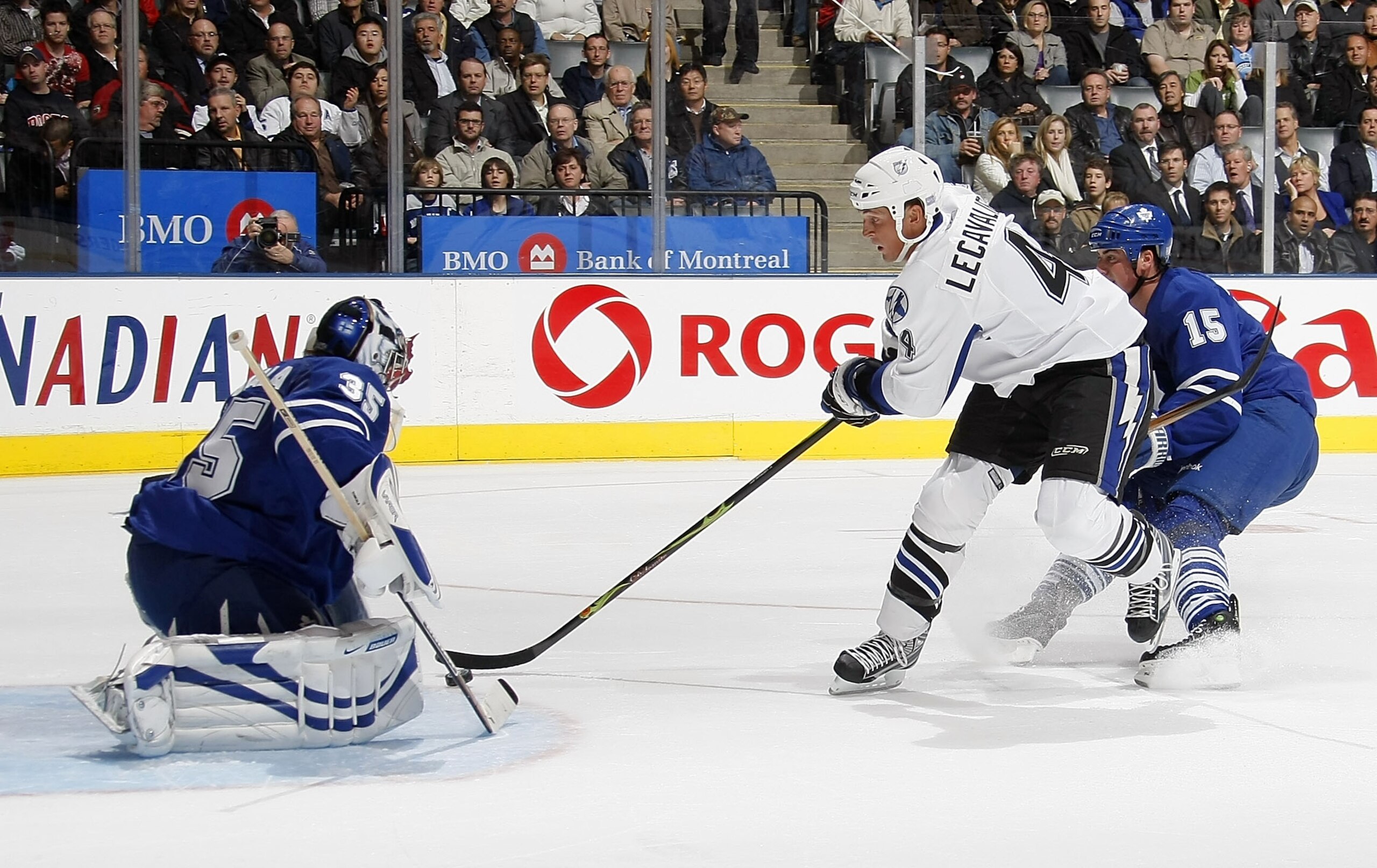 TORONTO - OCTOBER 28:   Vincent Lecavalier #4 of the Tampa Bay Lightning skates past Tomas Kaberle #15 of the Toronto Maple Leafs to score on Vesa Toskala #35 of the Toronto Maple Leafs during their NHL game at the Air Canada Centre October 28, 2008 in To