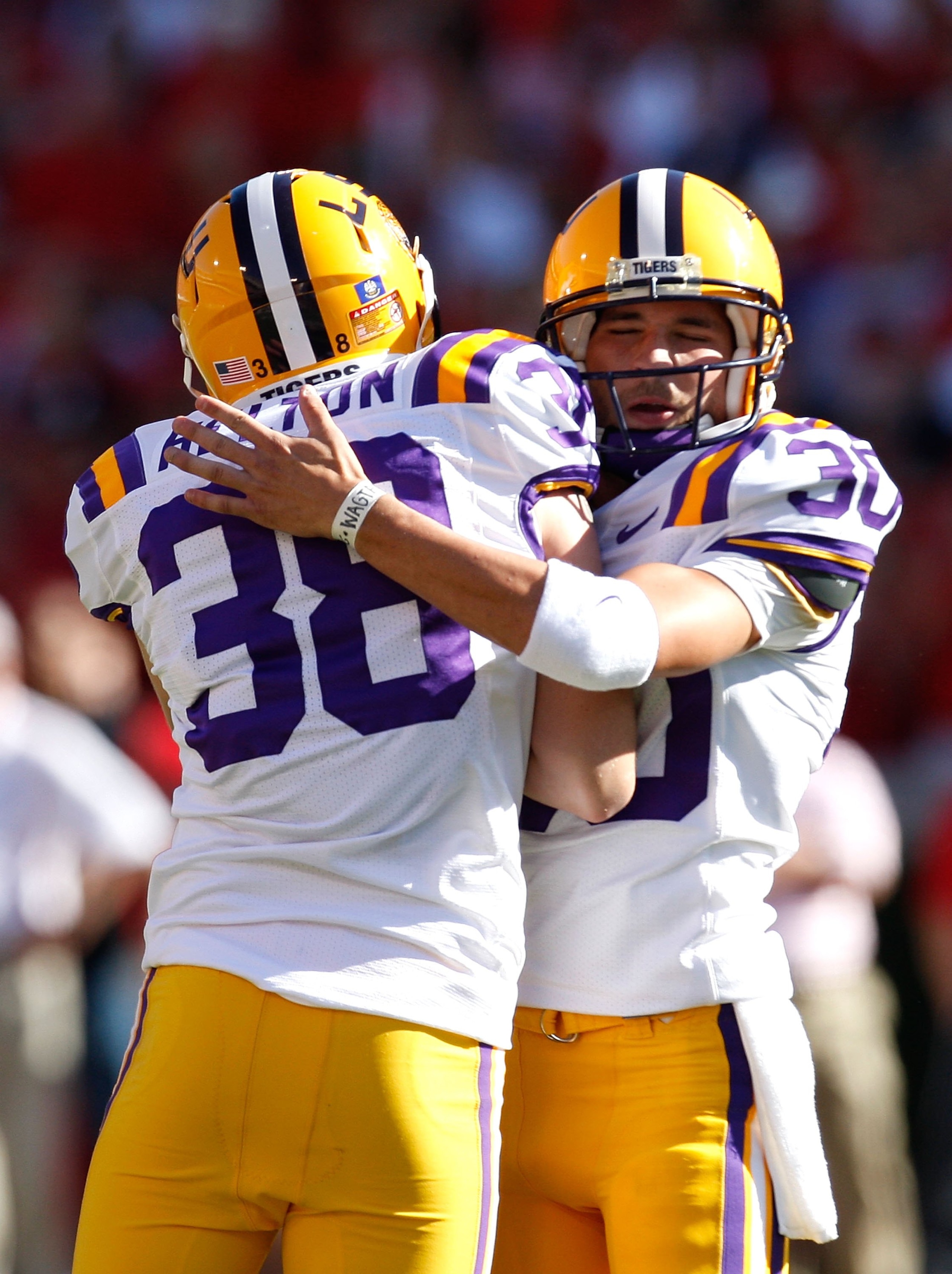 ATHENS, GA - OCTOBER 03:  Derek Helton #38 of the Louisiana State University Tigers lifts up kicker Josh Jasper #30 after his field goal against the Georgia Bulldogs at Sanford Stadium on October 3, 2009 in Athens, Georgia.  (Photo by Kevin C. Cox/Getty I