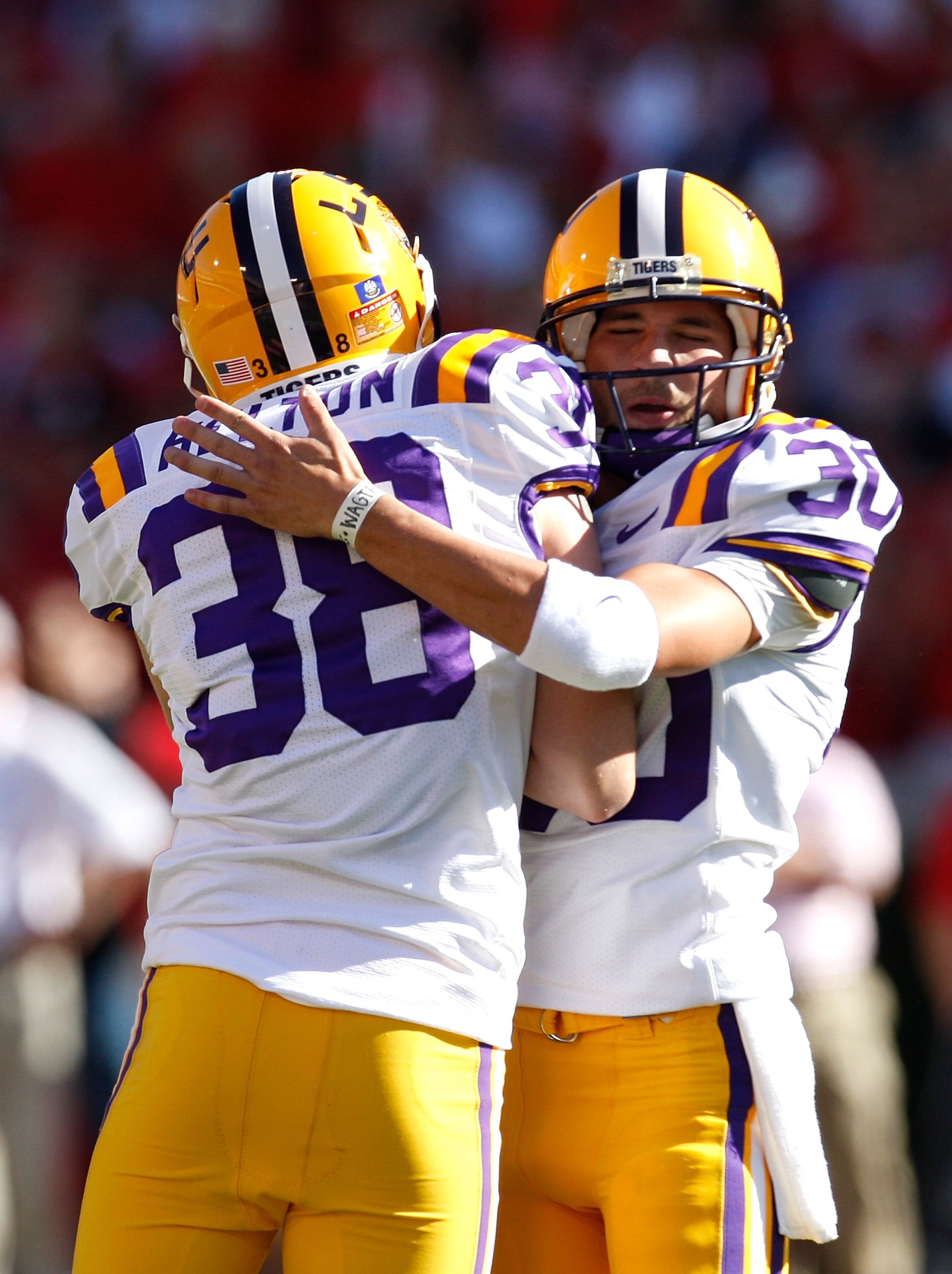 ATHENS, GA - OCTOBER 03:  Derek Helton #38 of the Louisiana State University Tigers lifts up kicker Josh Jasper #30 after his field goal against the Georgia Bulldogs at Sanford Stadium on October 3, 2009 in Athens, Georgia.  (Photo by Kevin C. Cox/Getty I