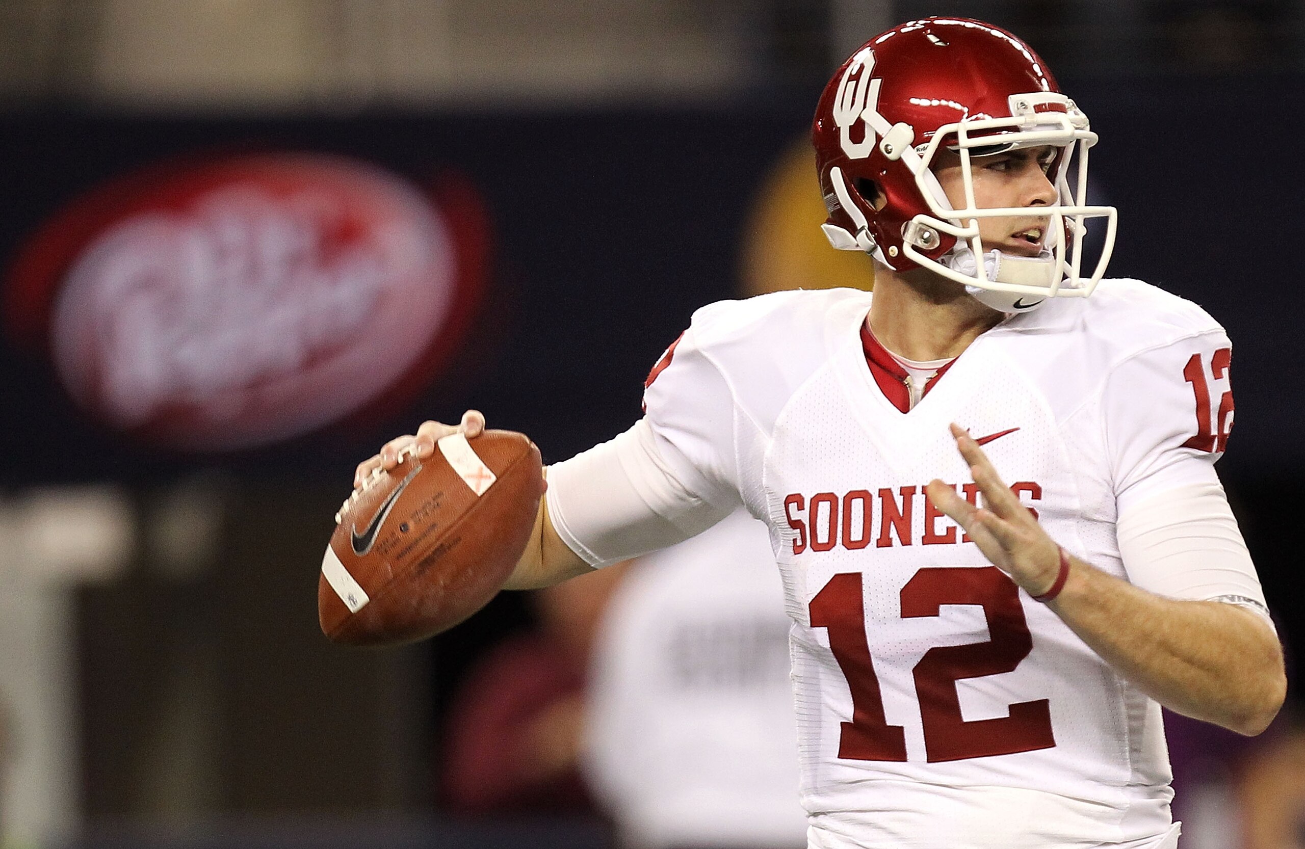ARLINGTON, TX - DECEMBER 04:  Quarterback Landry Jones #12 of the Oklahoma Sooners drops back to pass against the Nebraska Cornhuskers during the Big 12 Championship at Cowboys Stadium on December 4, 2010 in Arlington, Texas.  (Photo by Ronald Martinez/Ge