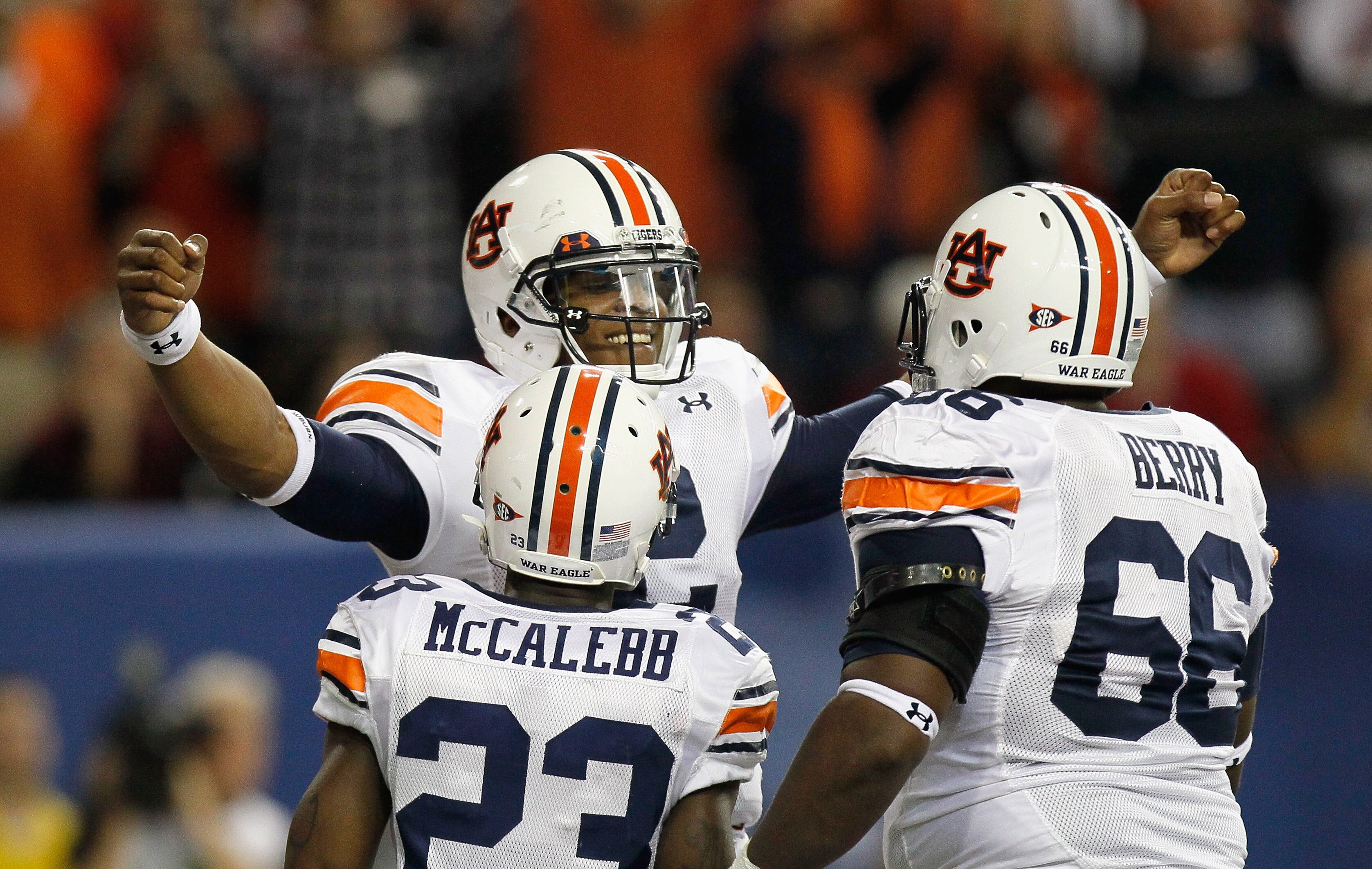 ATLANTA, GA - DECEMBER 04:  Quarterback Cam Newton #2 of the Auburn Tigers reacts after scoring a touchdown against the South Carolina Gamecocks with Onterio McCalebb #23 and Mike Berry #66 during the 2010 SEC Championship at Georgia Dome on December 4, 2
