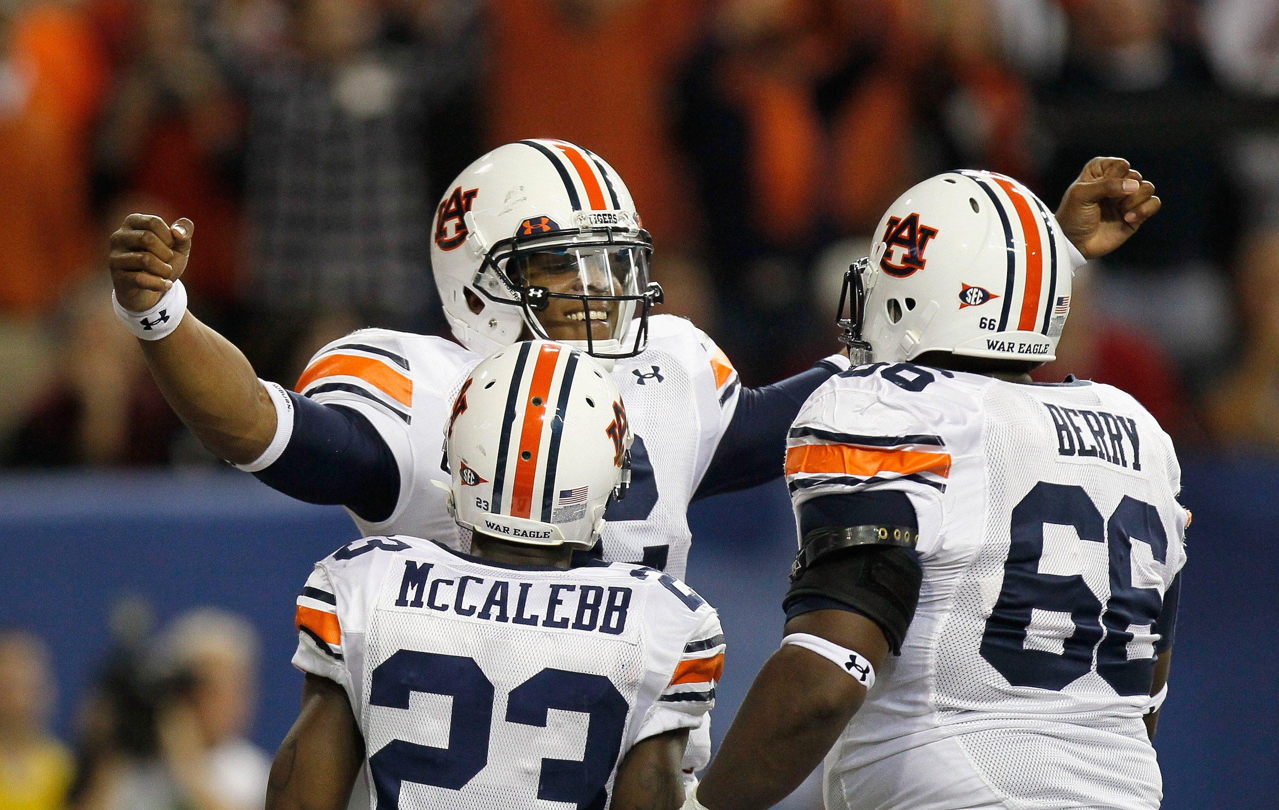 ATLANTA, GA - DECEMBER 04:  Quarterback Cam Newton #2 of the Auburn Tigers reacts after scoring a touchdown against the South Carolina Gamecocks with Onterio McCalebb #23 and Mike Berry #66 during the 2010 SEC Championship at Georgia Dome on December 4, 2