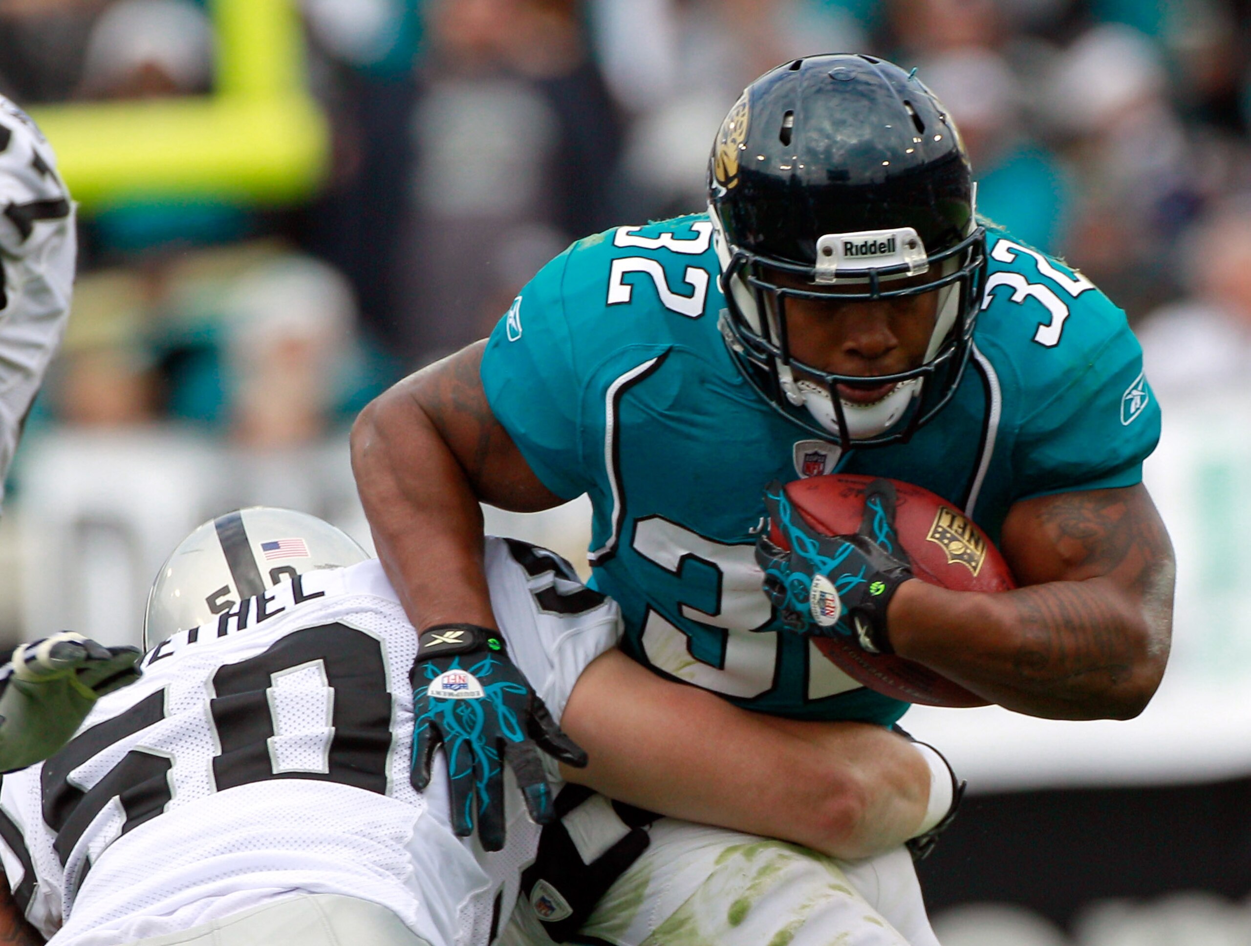 JACKSONVILLE, FL - DECEMBER 12: Maurice Jones-Drew #32 of the Jacksonville Jaguars breaks the tackle of Travis Goethel #50 of the Oakland Raiders during the game at EverBank Field on December 12, 2010 in Jacksonville, Florida. (Photo by Sam Greenwood/Ge JACKSONVILLE, FL - DECEMBER 12: Maurice Jones-Drew #32 of the Jacksonville Jaguars breaks the tackle of Travis Goethel #50 of the Oakland Raiders during the game at EverBank Field on December 12, 2010 in Jacksonville, Florida. (Photo by Sam Greenwood/Ge