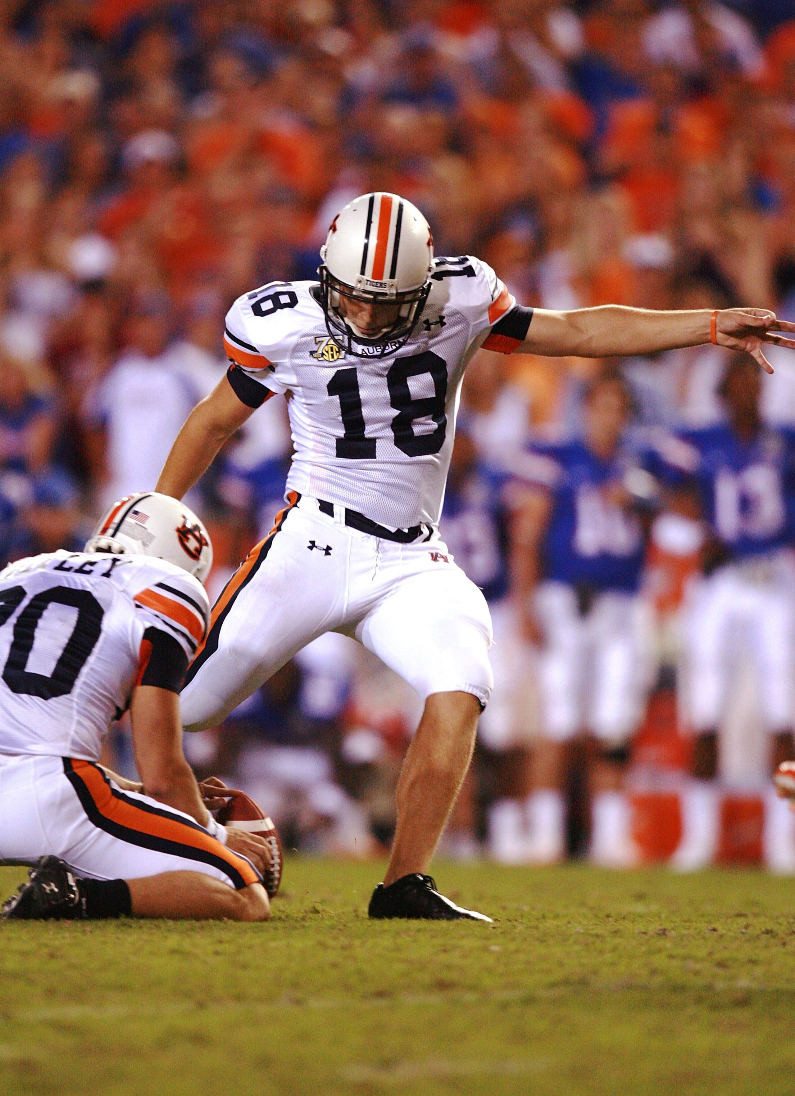 GAINESVILLE, FL - SEPTEMBER 29:  Place kicker Wes Byrum #18 of the Auburn Tigers kicks the game-winning kick out of the hold of Matthew Motley #20 as time expires against the Florida Gators at Ben Hill Griffin Stadium September 29, 2007 in Gainesville, Fl