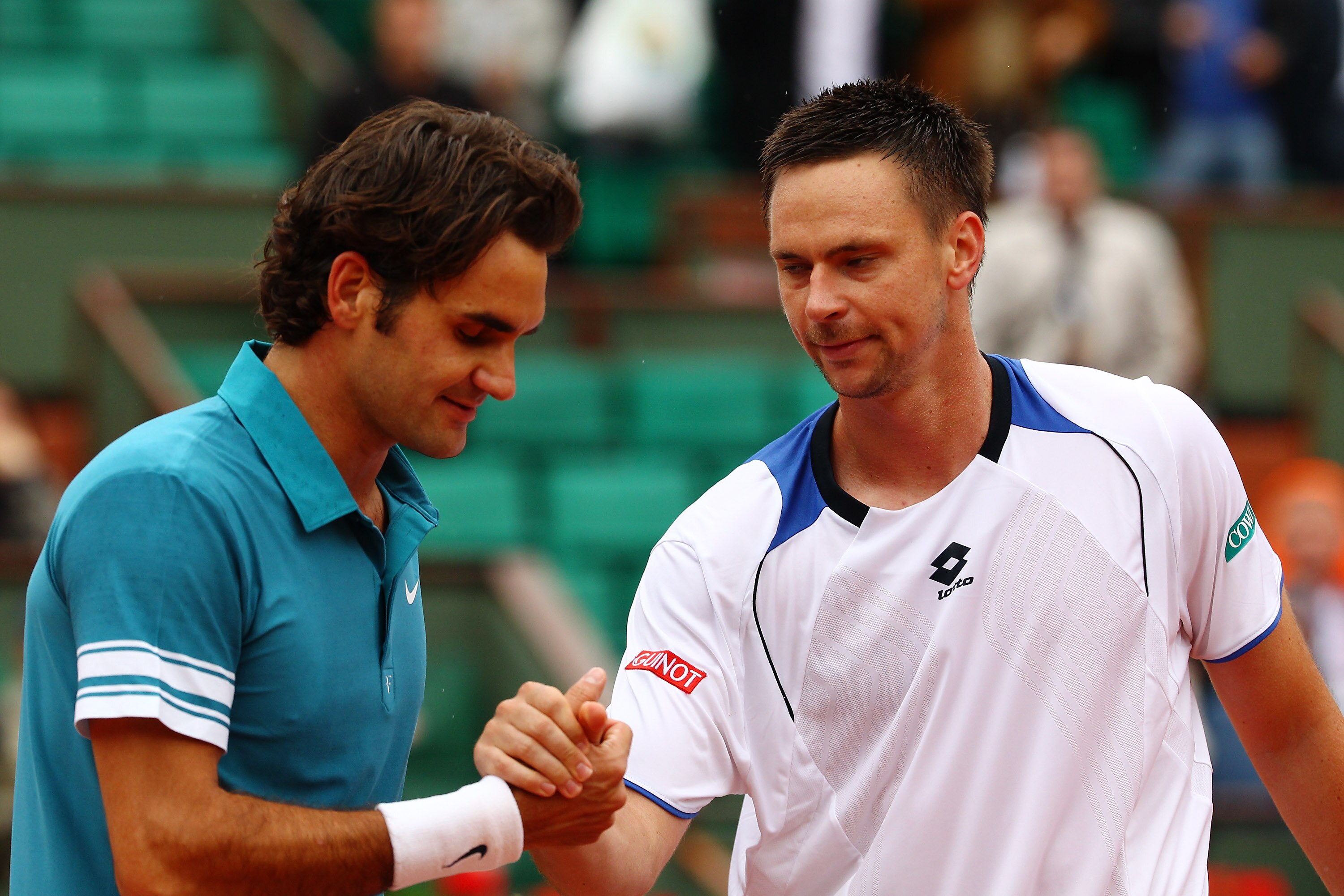PARIS - JUNE 01:  Roger Federer of Switzerland shakes hands with Robin Soderling of Sweden after the men's singles quarter final match between Robin Soderling of Sweden and Roger Federer of Switzerland at the French Open on day ten of the French Open at R