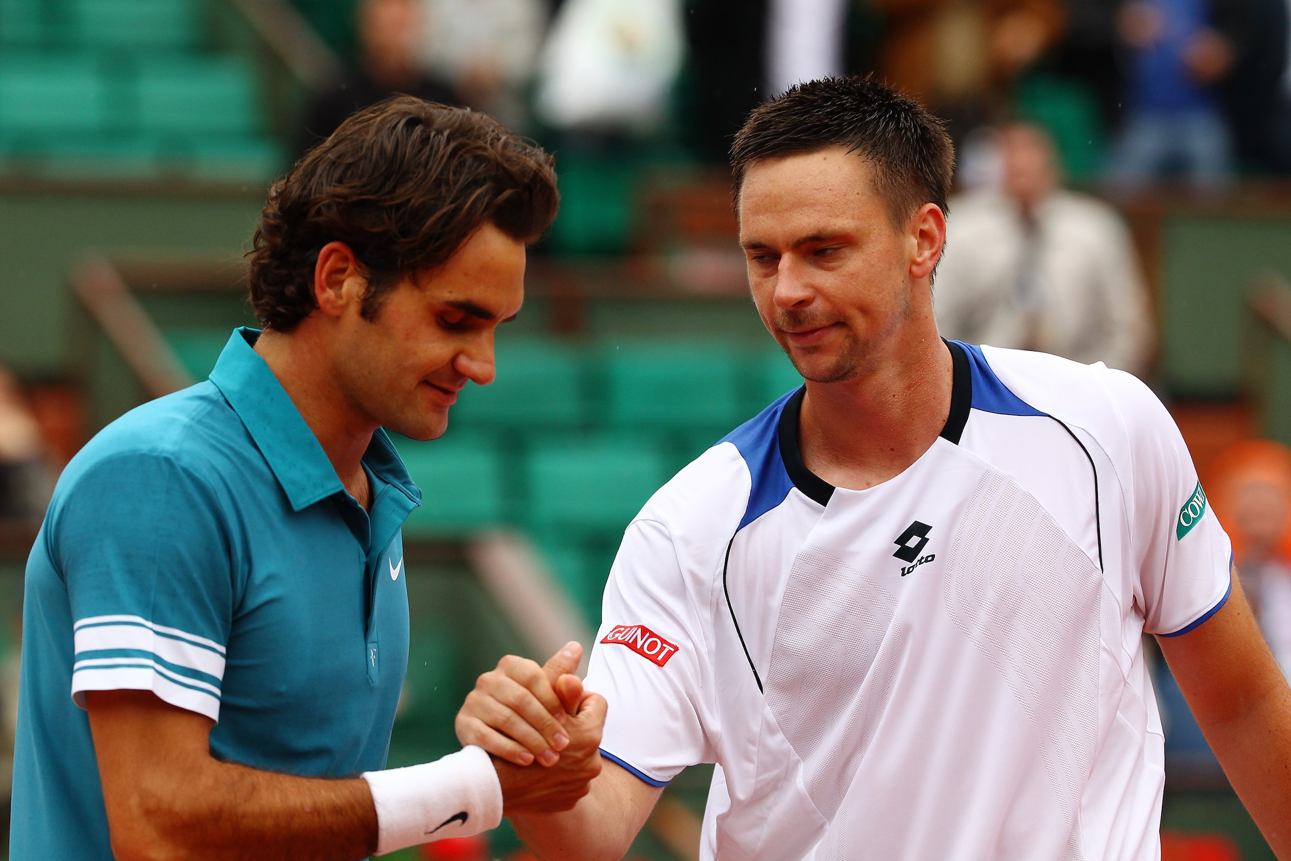 PARIS - JUNE 01:  Roger Federer of Switzerland shakes hands with Robin Soderling of Sweden after the men's singles quarter final match between Robin Soderling of Sweden and Roger Federer of Switzerland at the French Open on day ten of the French Open at R