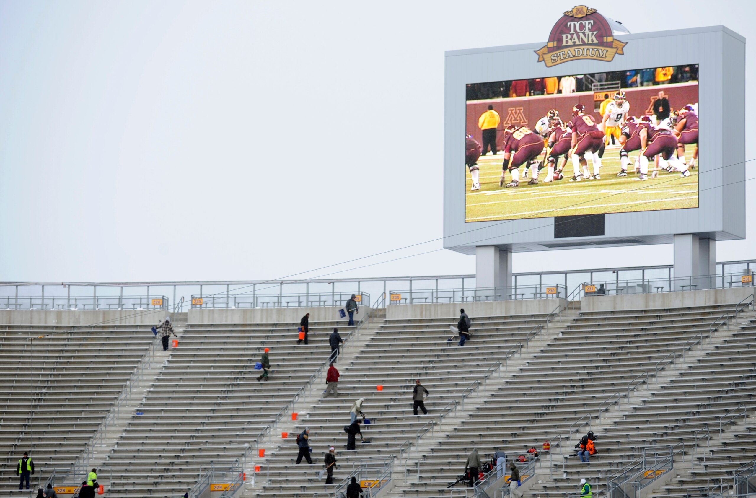 MINNEAPOLIS, MN - DECEMBER 17: Workers remove snow from the upper deck as TCF Bank Stadium prepares for a potential monday night football game between the Minnesota Vikings and Chicago Bears on December 17, 2010 in Minneapolis, Minnesota. Preparations are