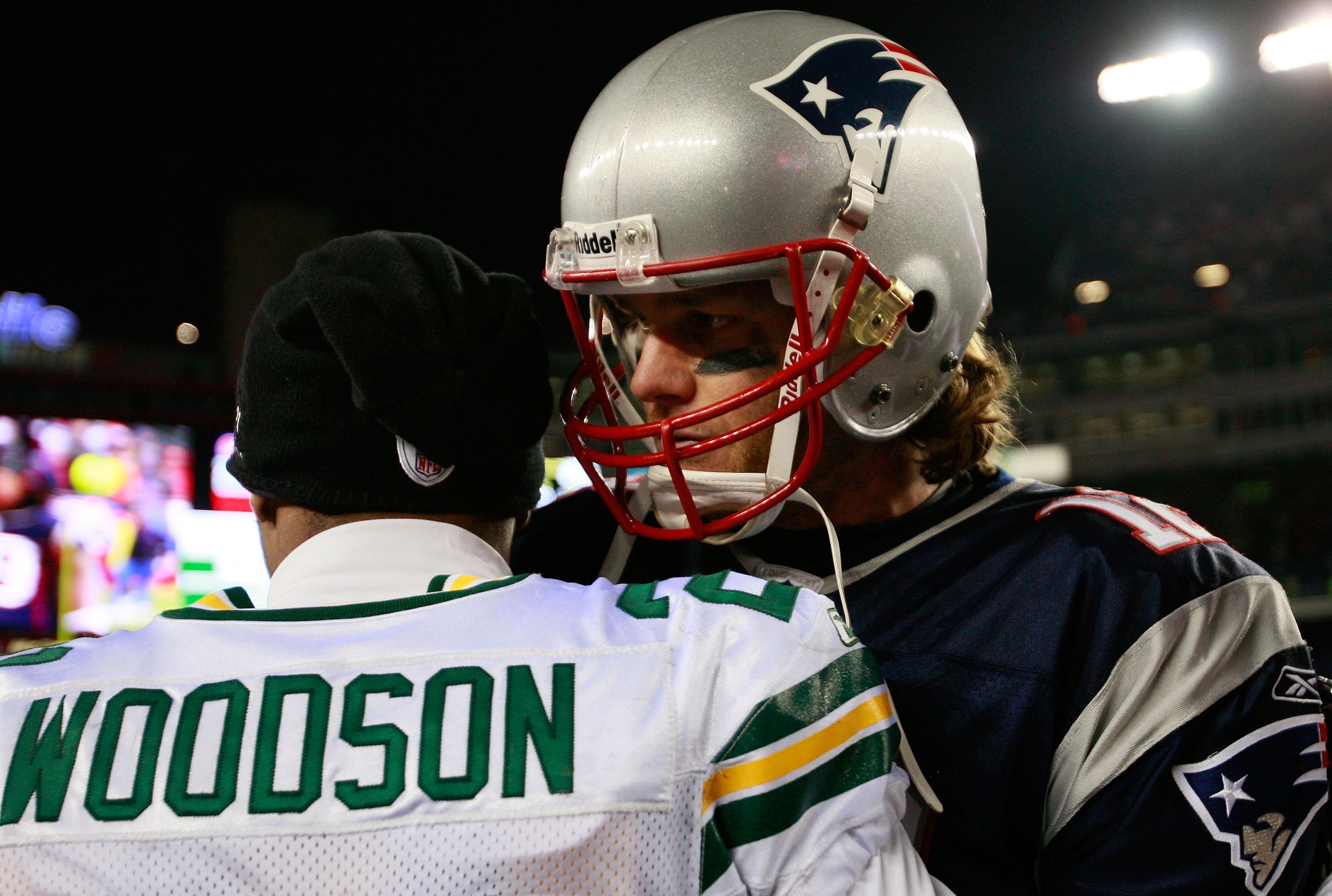 FOXBORO, MA - DECEMBER 19:  Quarterback Tom Brady #12 of the New England Patriots is congratulated by cornerback Charles Woodson #21 of the Green Bay Packers at Gillette Stadium on December 19, 2010 in Foxboro, Massachusetts. The Patriots won the game 31-
