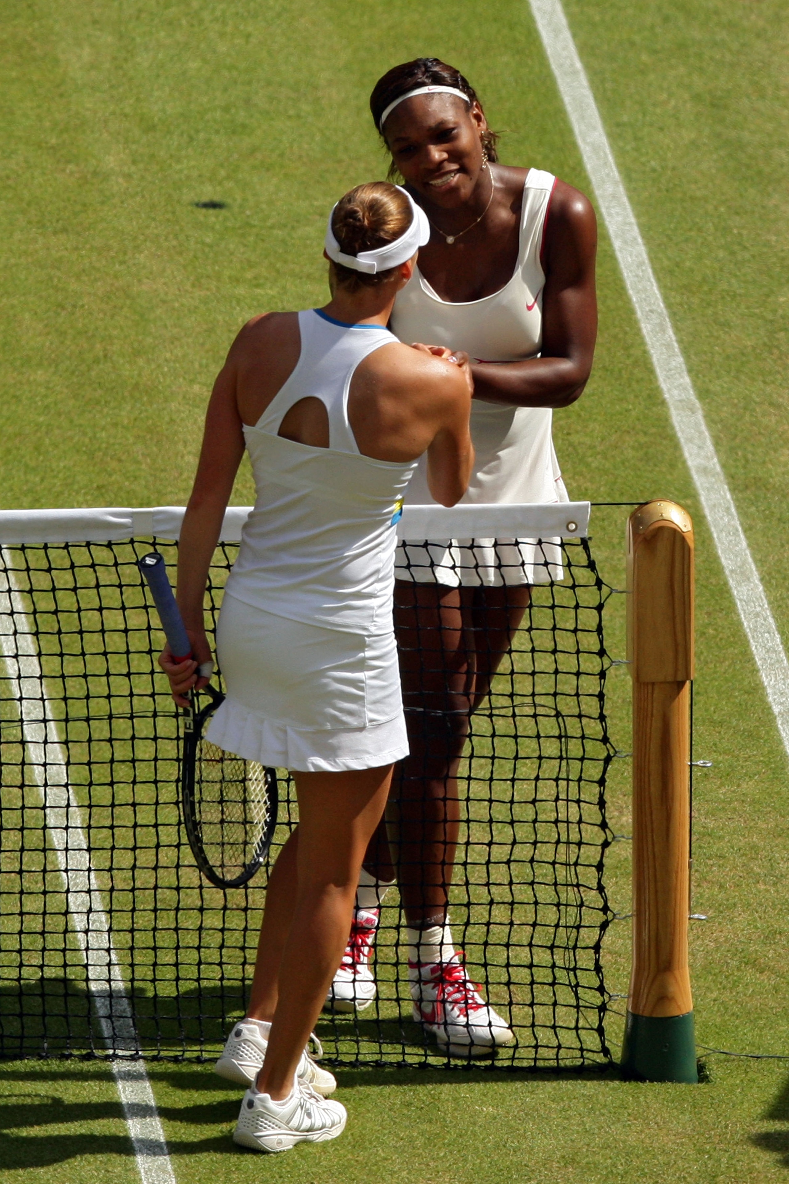 LONDON, ENGLAND - JULY 03:  Serena Williams of USA (R) shakes hands after winning her Ladies Singles Final Match against Vera Zvonareva of Russia on Day Twelve of the Wimbledon Lawn Tennis Championships at the All England Lawn Tennis and Croquet Club on J