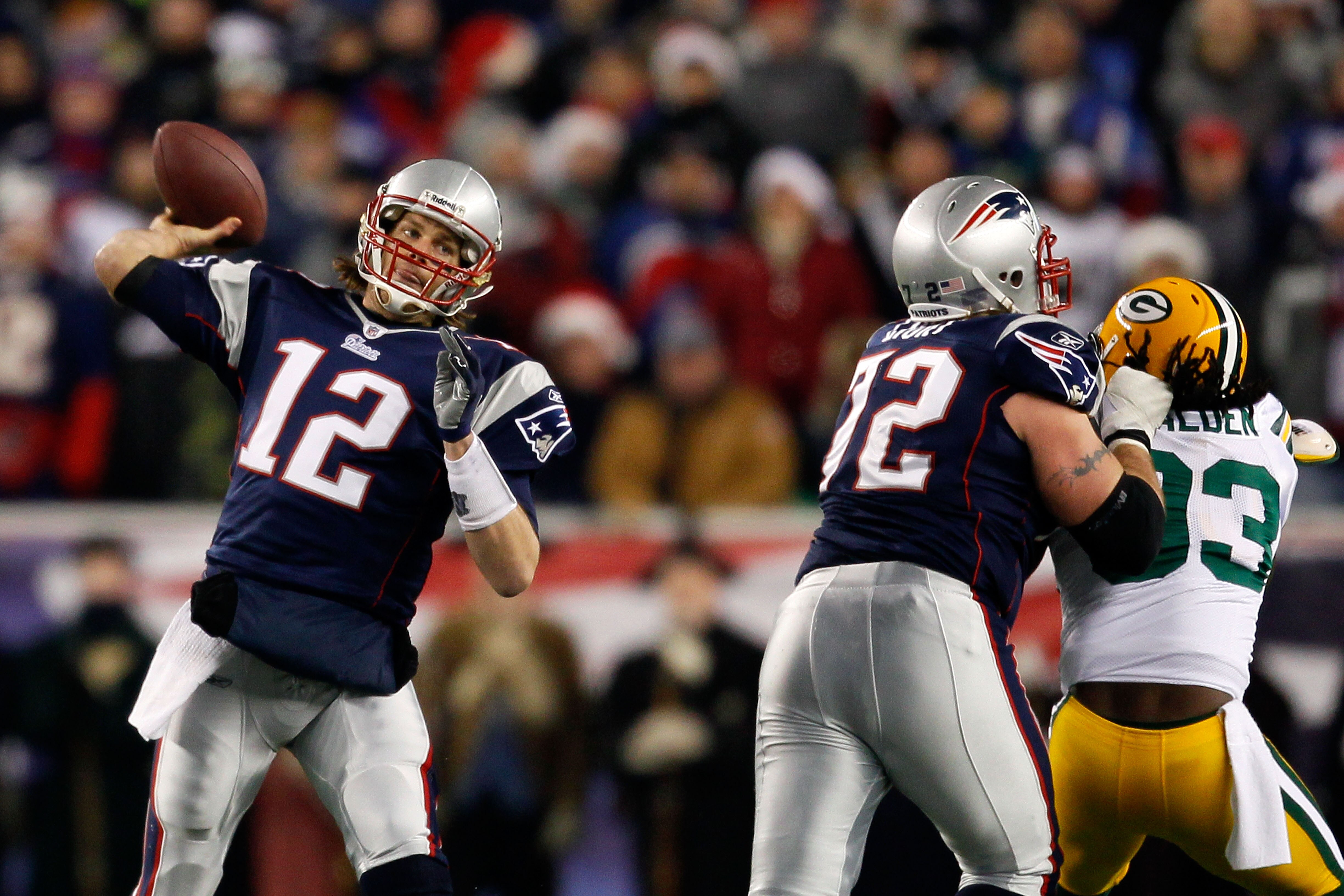 FOXBORO, MA - DECEMBER 19:  Quarterback Tom Brady #12 of the New England Patriots throws a pass as tackle Matt Light #72 blocks linebacker Erik Walden #93 of the Green Bay Packers in the first quarter of the game at Gillette Stadium on December 19, 2010 i