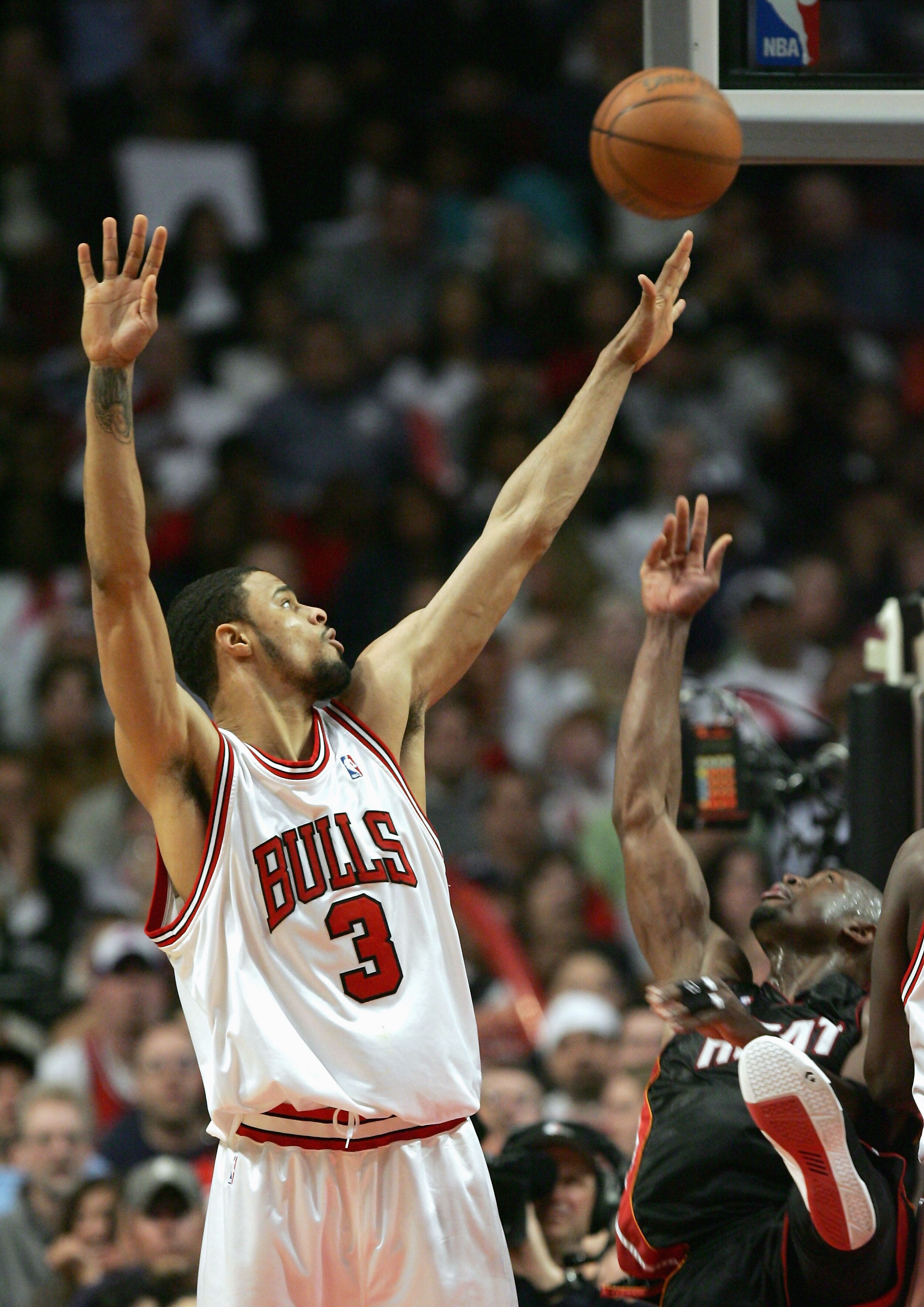 CHICAGO - APRIL 27:  Tyson Chandler #3 of the Chicago Bulls takes a jump shot against Gary Payton #20 of the Miami Heat in game three of the Eastern Conference Quarterfinals during the 2006 NBA Playoffs on April 27, 2006 at the United Center in Chicago, I
