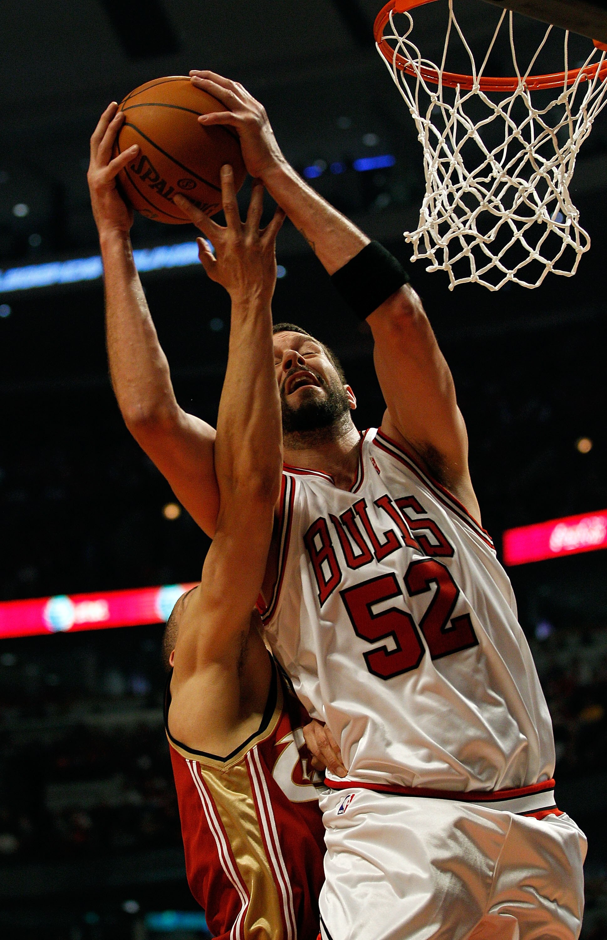 CHICAGO - APRIL 25: Brad Miller #52 of the Chicago Bulls grabs a rebound as Anthony Parker #18 of the Cleveland Cavaliers reaches around in Game Four of the Eastern Conference Quarterfinals during the 2010 NBA Playoffs at the United Center on April 25, 20