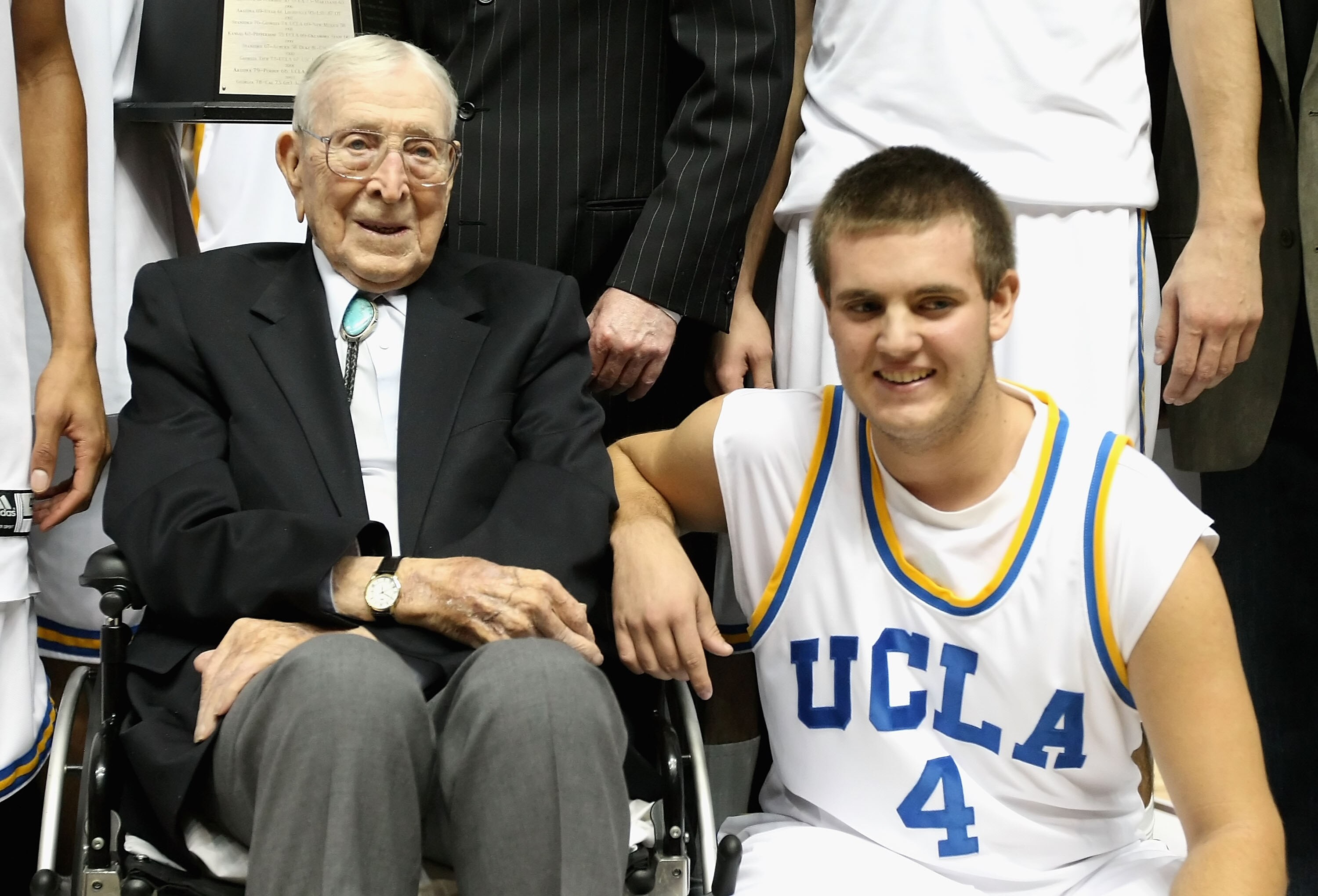 ANAHEIM, CA - DECEMBER 13:  Former coach John Wooden poses with great grandson Tyler Trapani #4 of the UCLA Bruins after the John R. Wooden Classic game against the DePaul Blue Demons at Honda Center on December 13, 2008 in Anaheim, California. The Bruins