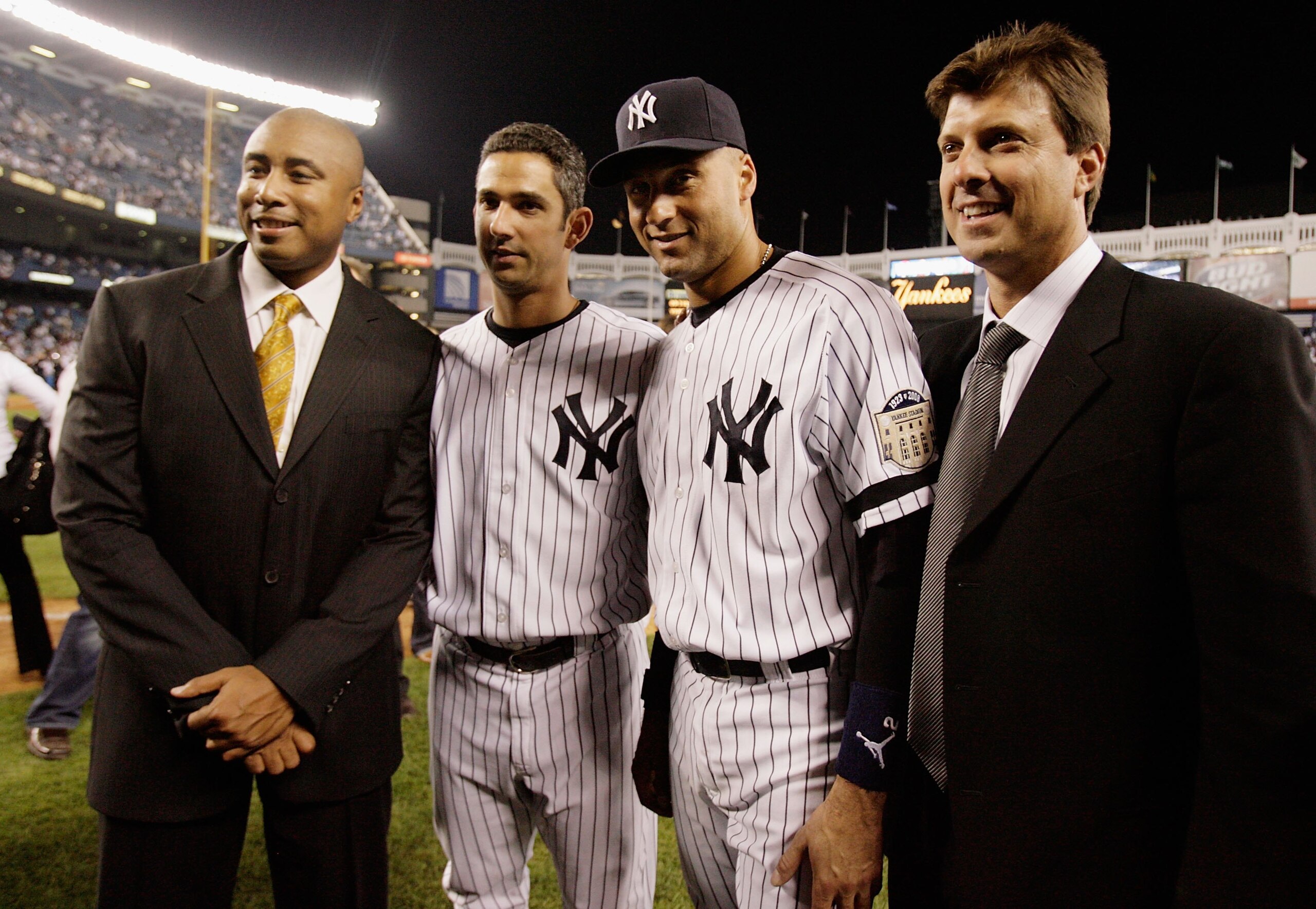 NEW YORK - SEPTEMBER 21: Former the New York Yankees Bernie Williams (L) and Tino Martinez (R) pose for a photograph with Jorge Posada #20 (2nd L) and Derek Jeter #2 after the last regular season game at Yankee Stadium on September 21, 2008 in the Bronx b