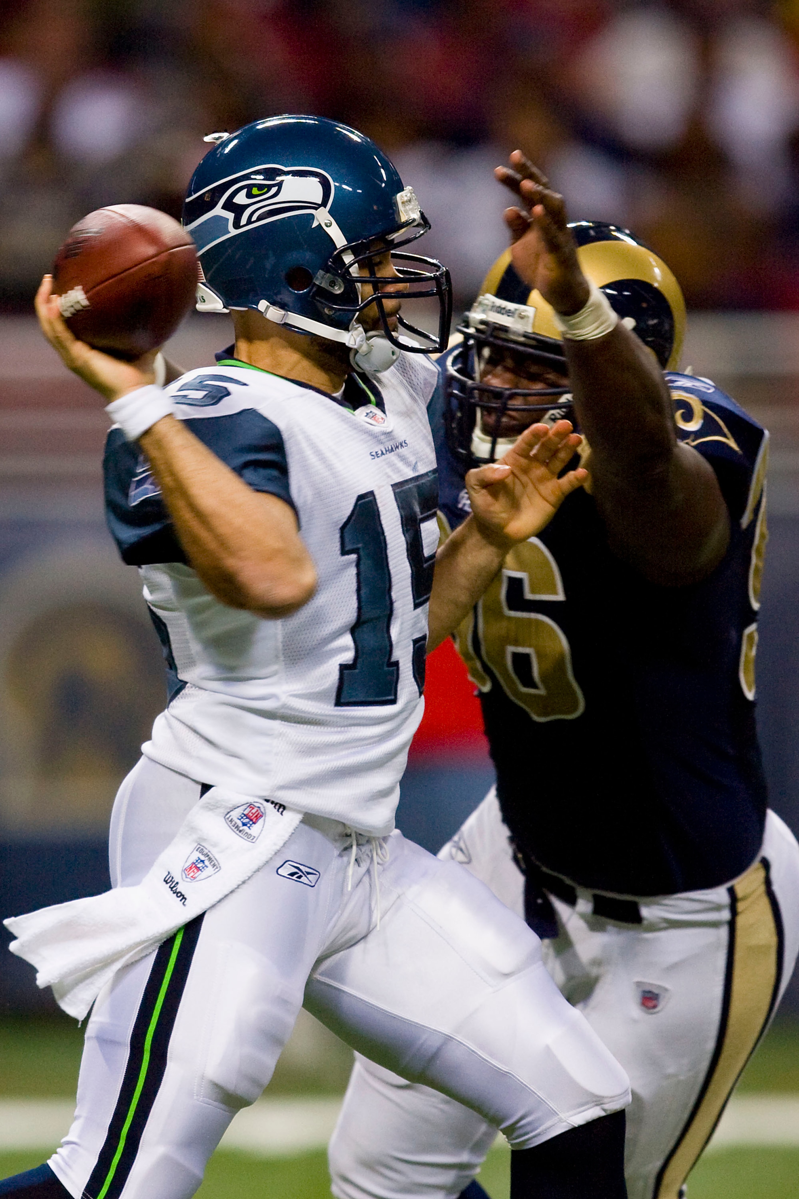 ST. LOUIS, MO - DECEMBER 14:  Seneca Wallace #15 of the Seattle Seahawks passes against James Hall #96 of the St. Louis Rams at the Edward Jones Dome on December 14, 2008 in St. Louis, Missouri.  The Seahawks beat the Rams 23-20.  (Photo by Dilip Vishwana
