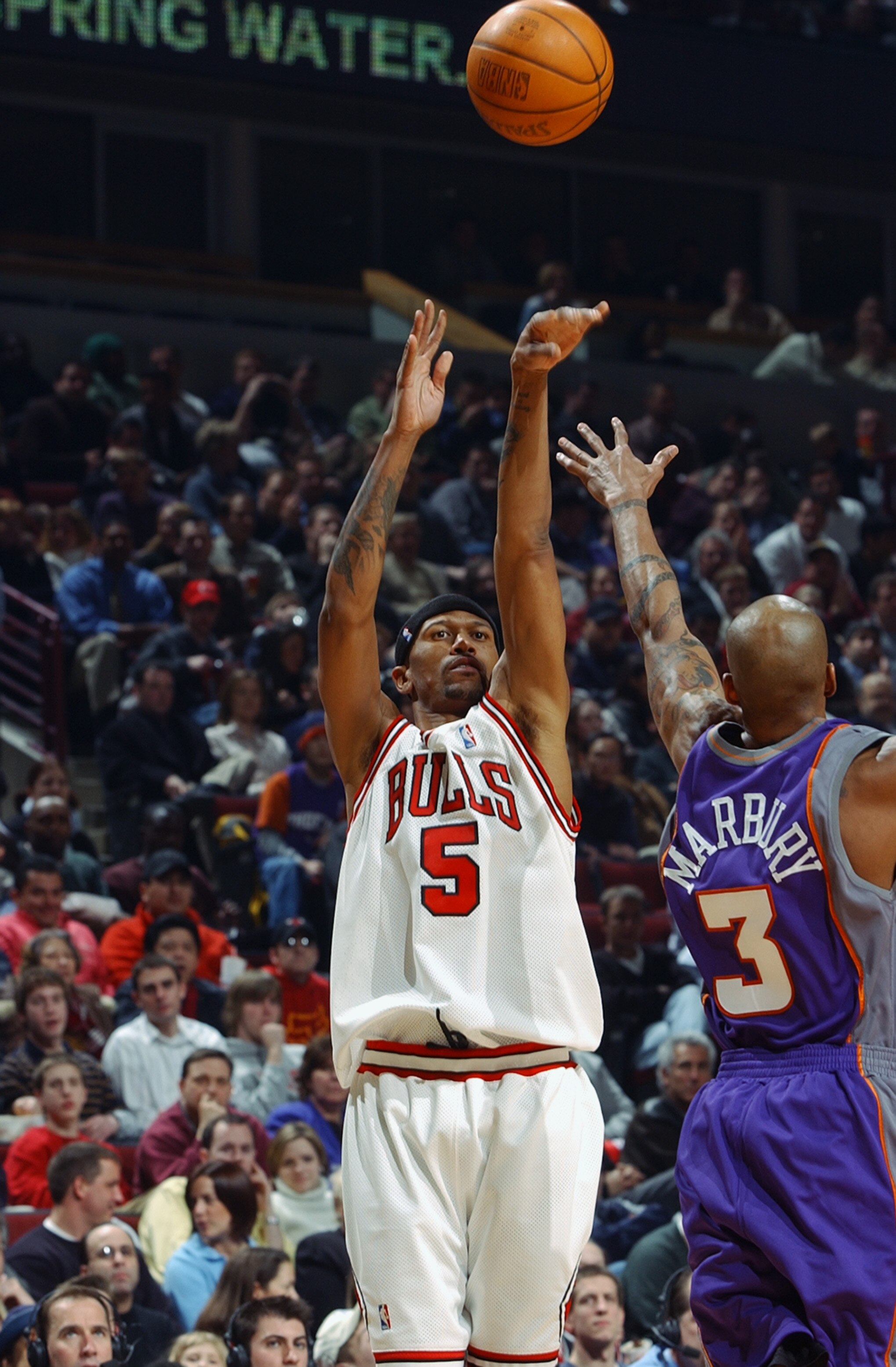 CHICAGO - FEBRUARY 24: Jalen Rose#5 of the Chicago Bulls shoots over Stephon Marbury#3 of the Phoenix Suns during the game at United Center on February 24, 2003 in Chicago, Illinois.  The Bulls won 90-87.  NOTE TO USER: User expressly acknowledges and agr