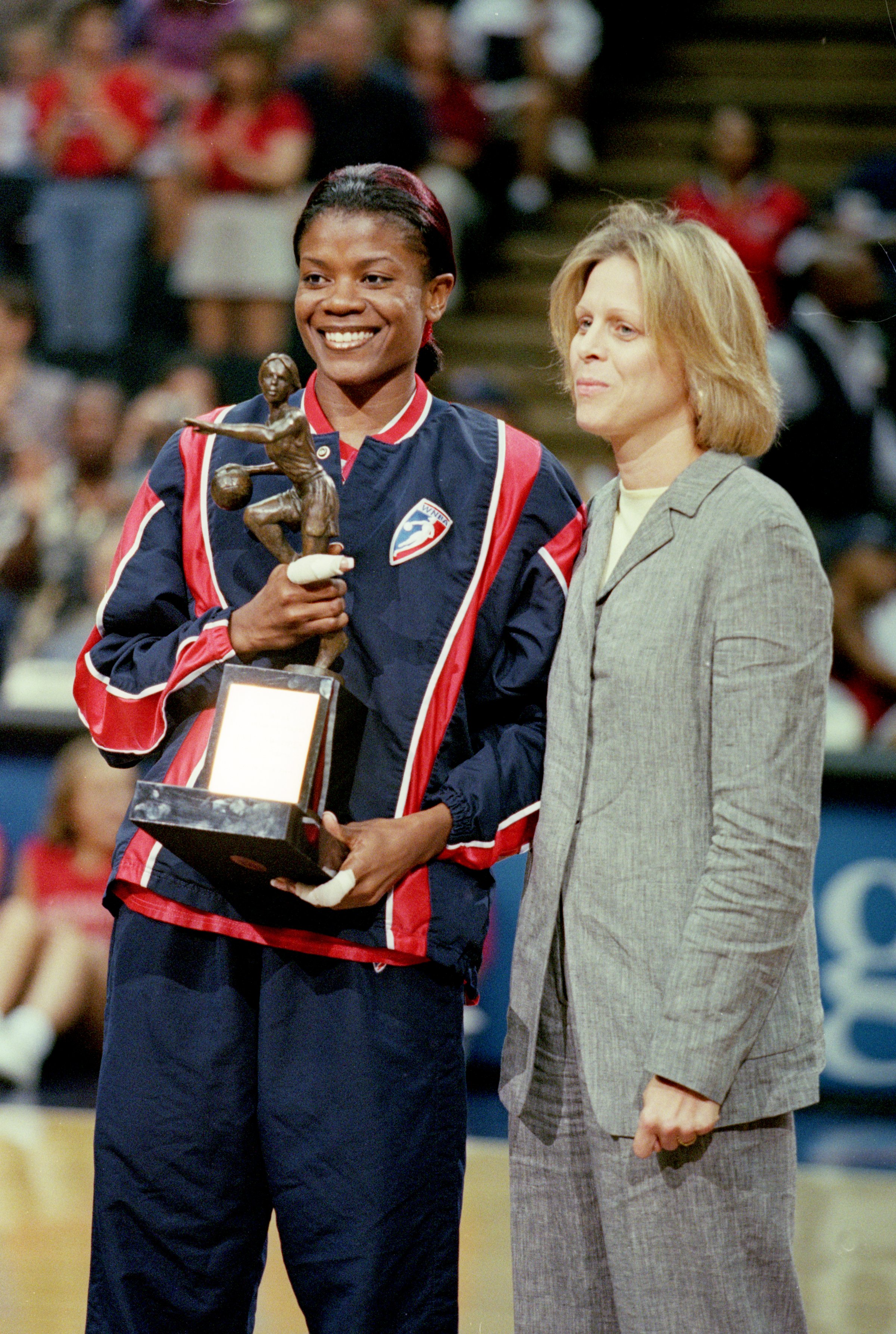 17 Aug 2000:  Sheryl Swoops #22 of the Houston Comets poses with her trophy and WNBA President Val Ackerman after the WNBA Playoff Game 1 against the  Los Angeles Sparks at the Compaq Center in Houston, Texas.  The Comets defeated the Sparks 77-56.  NOTE