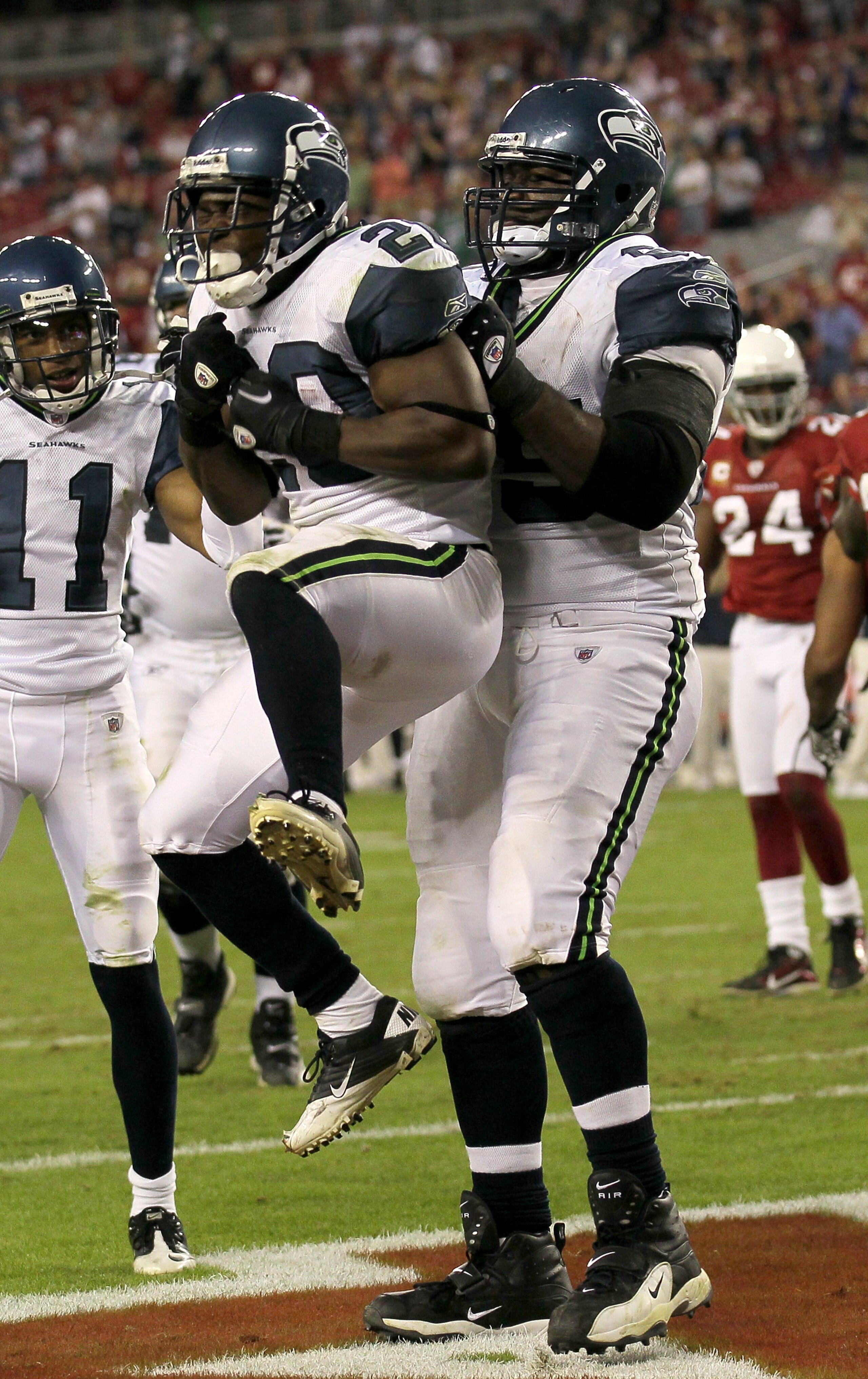 GLENDALE, AZ - NOVEMBER 14:  Running back Justin Forsett #20 of the Seattle Seahawks is lifted by center Chris Spencer #65 as they celelbrate his four yard touchdown carry against the Arizona Cardinals in the fourth quarter at University of Phoenix Stadiu