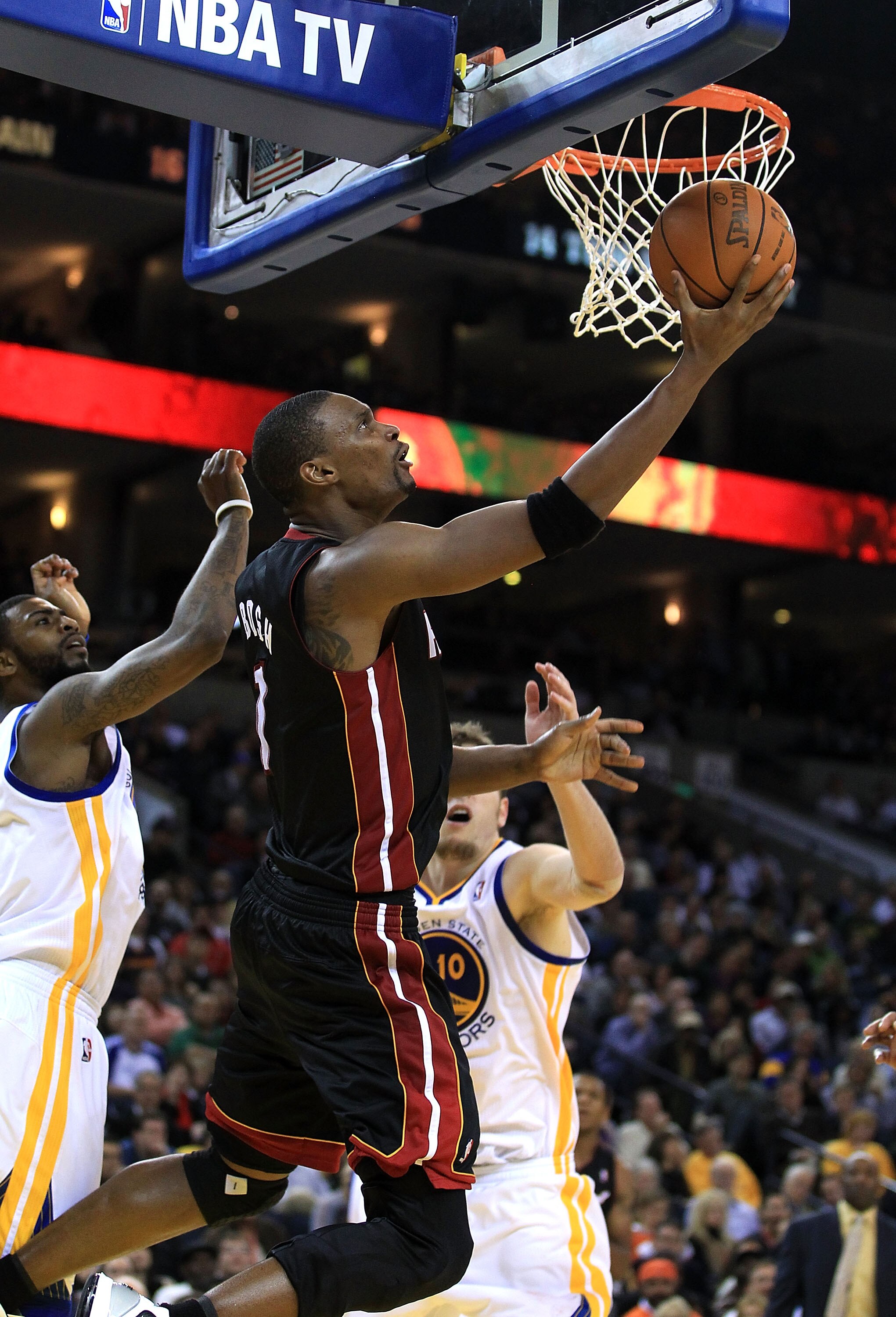 OAKLAND, CA - DECEMBER 10:  Chris Bosh #1 of the Miami Heat goes up for a shot against the Golden State Warriors at Oracle Arena on December 10, 2010 in Oakland, California. NOTE TO USER: User expressly acknowledges and agrees that, by downloading and or 