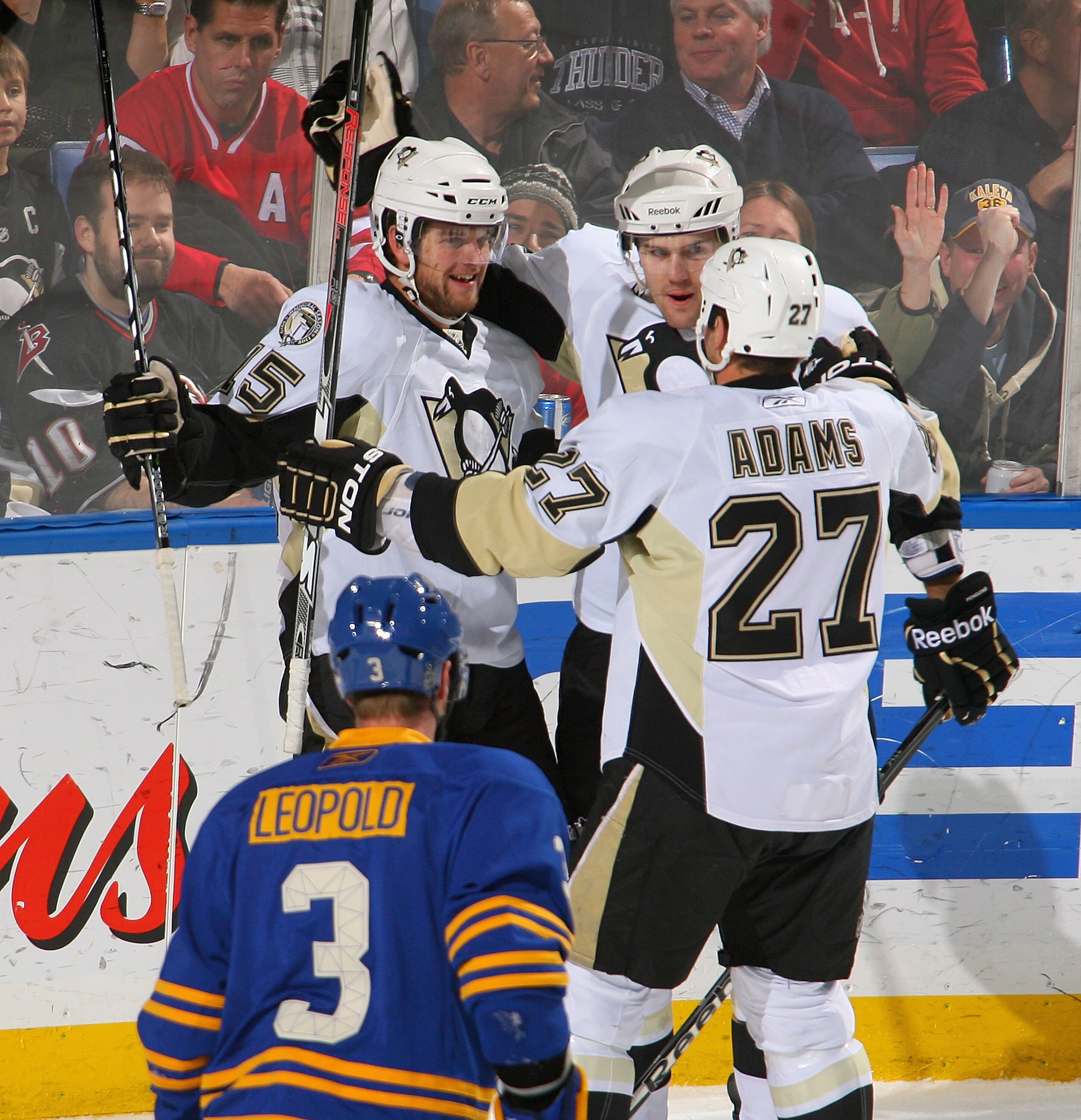 BUFFALO, NY - DECEMBER 11: Dustin Jeffrey #15, Ben Lovejoy #6 and Craig Adams #27  of the Pittsburgh Penguins  celebrate Jeffrey's goal in the first period against the Buffalo Sabres  at HSBC Arena on December 11, 2010 in Buffalo, New York.  (Photo by Ric