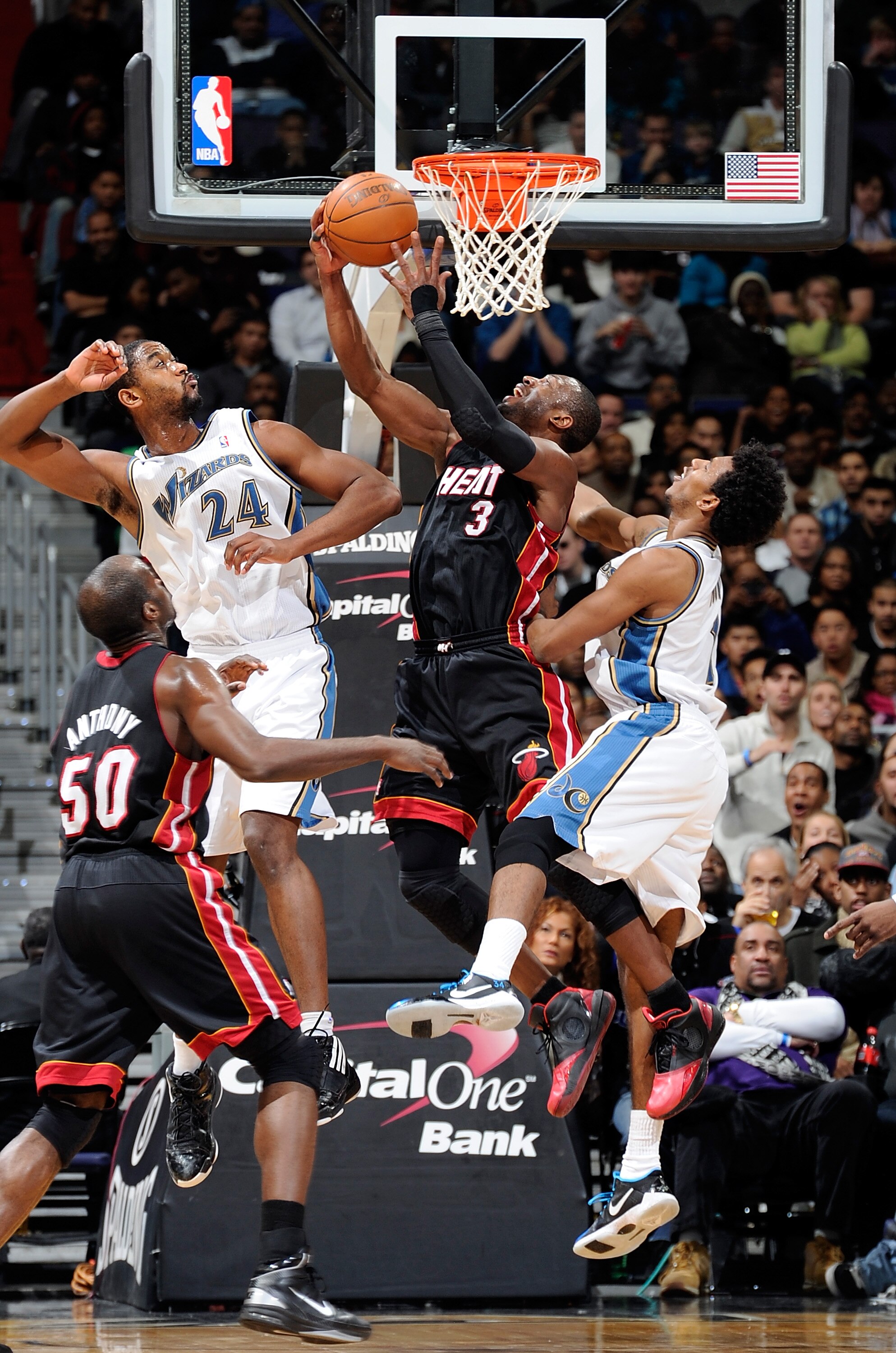 WASHINGTON - DECEMBER 18:  Dwyane Wade #3 of the Miami Heat drives to the hoop against Hilton Armstron #24 and Nick Young #1 of the Washington Wizards at the Verizon Center on December 18, 2010 in Washington, DC.  NOTE TO USER: User expressly acknowledges